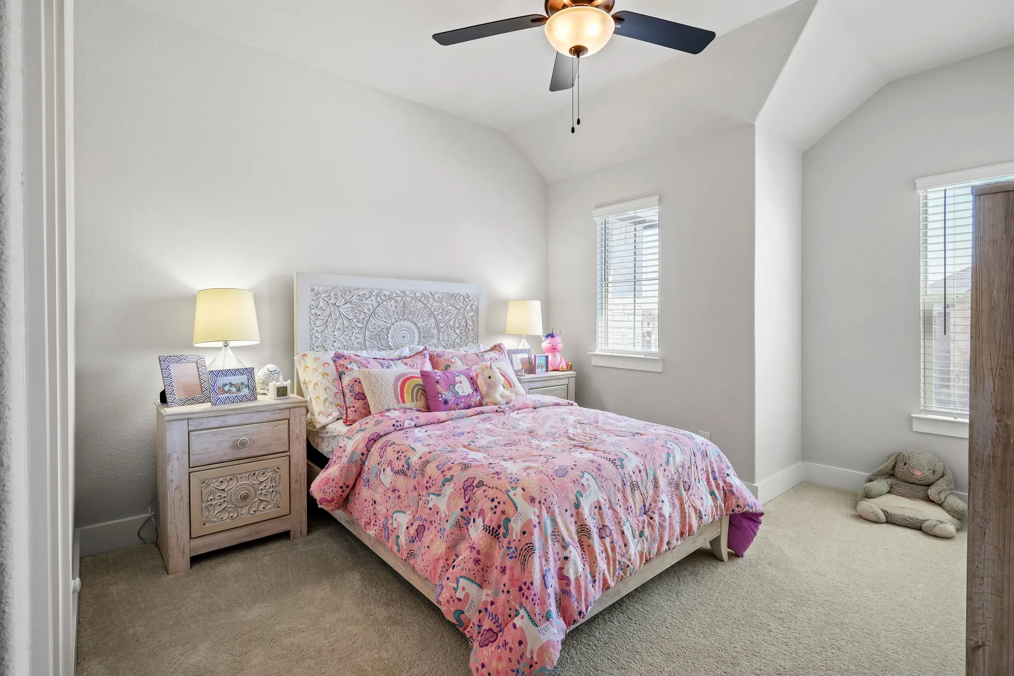 Bedroom with ceiling fan, vaulted ceiling, and carpet