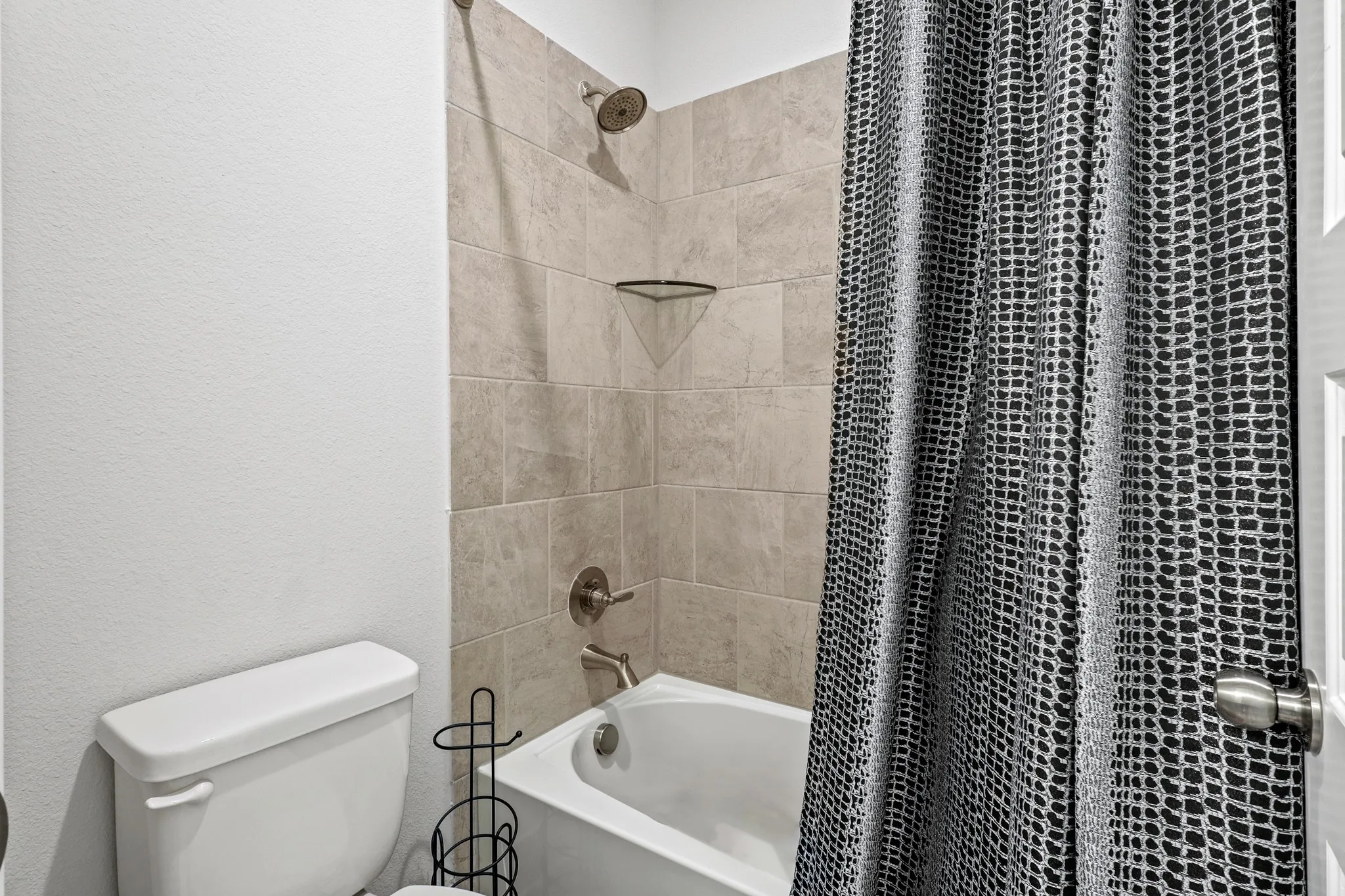 Bathroom with shower / tub combo and toilet
