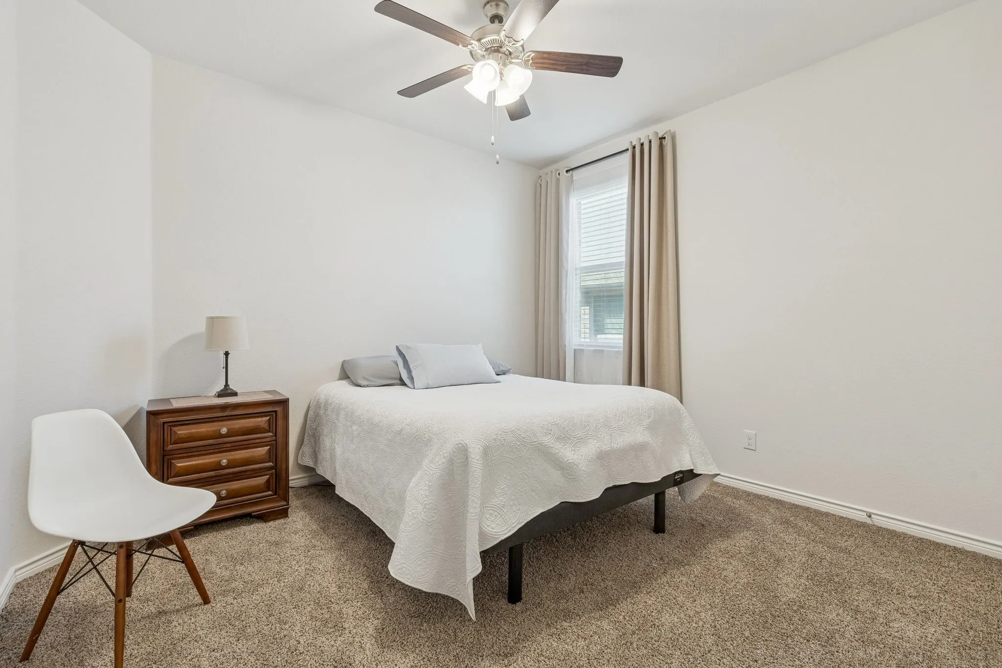 Bedroom with carpet flooring and a ceiling fan