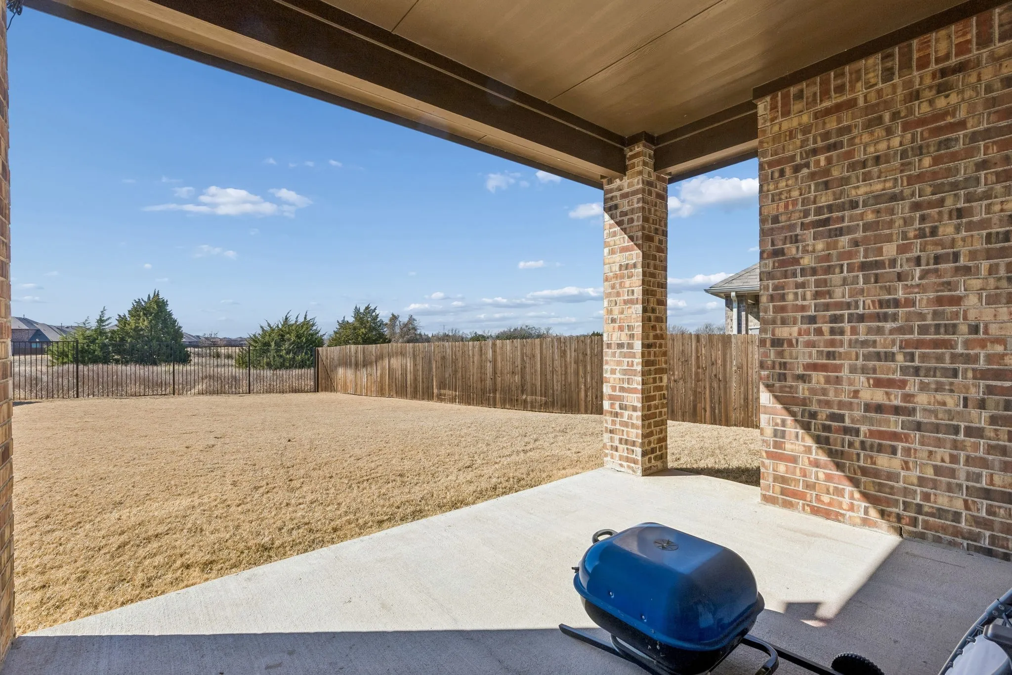 Fenced backyard featuring a patio area