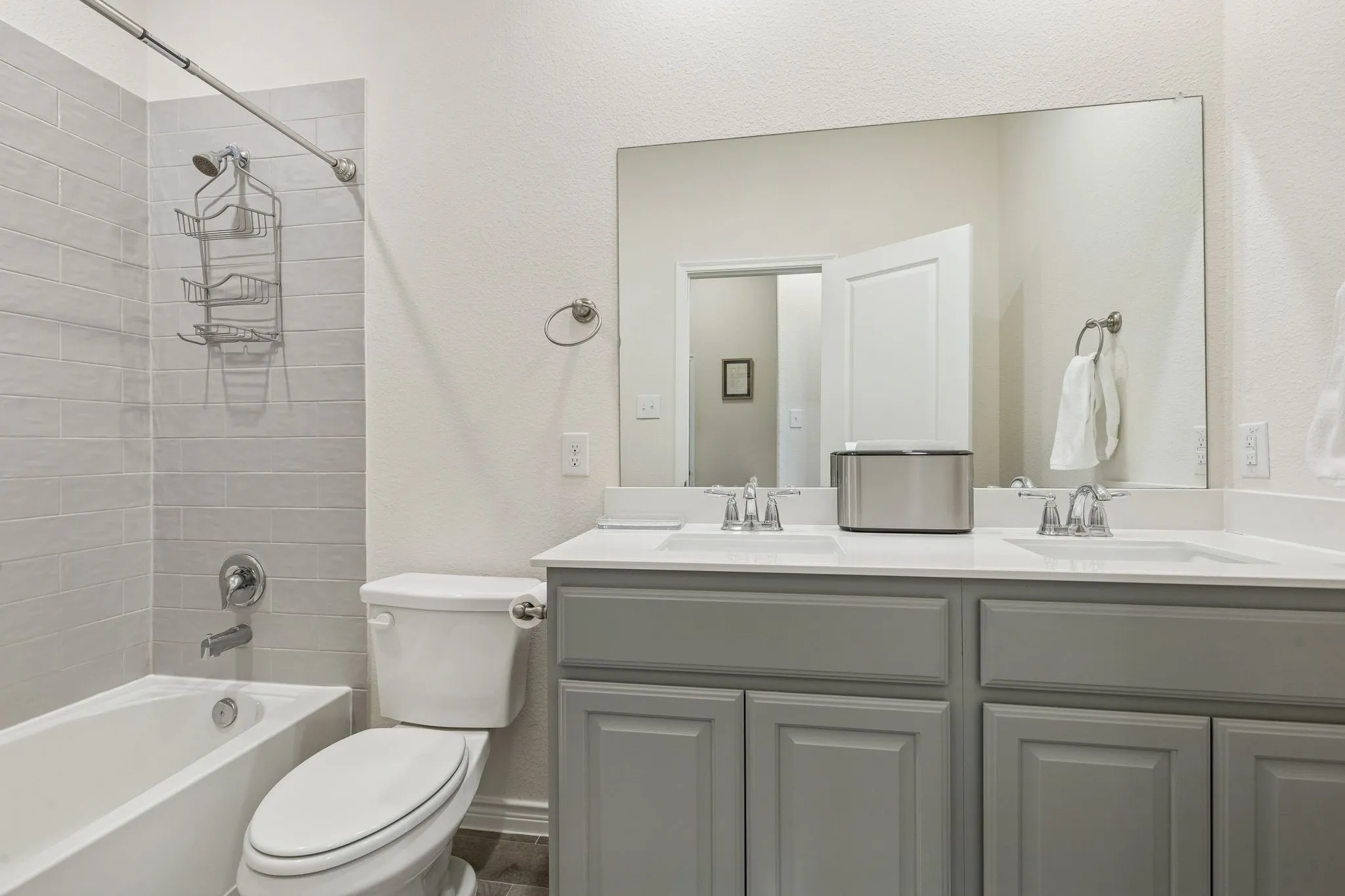 Bathroom with double vanity and shower / bath combination