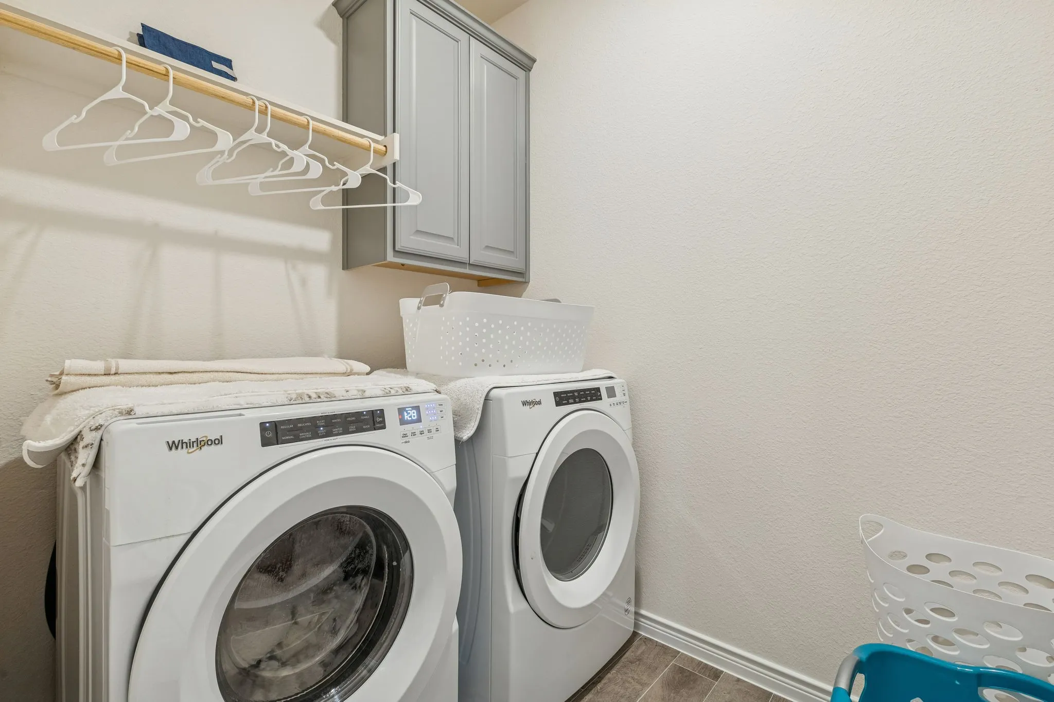 Laundry area featuring cabinet space and washer and clothes dryer