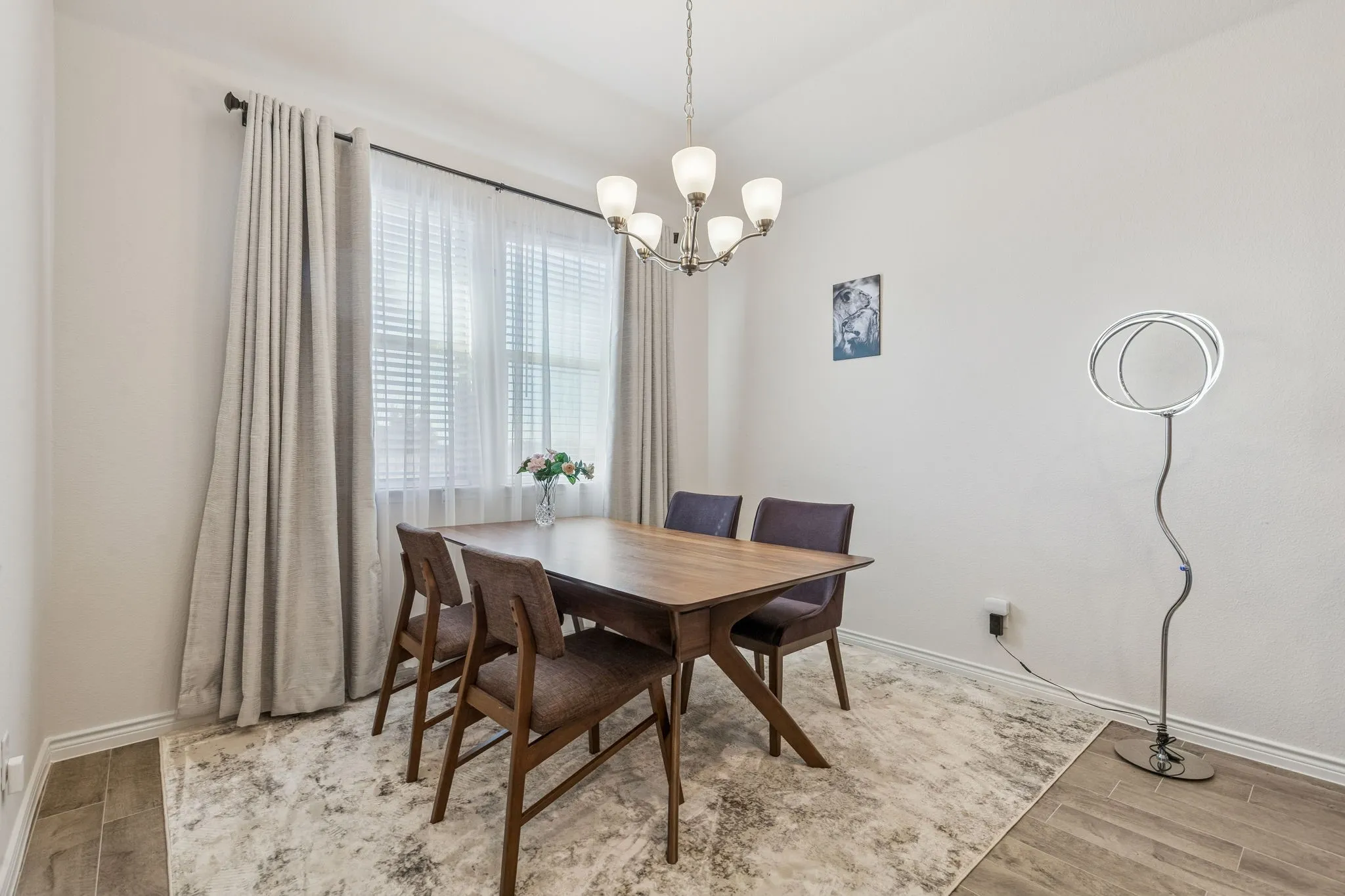 Dining area featuring suspended lighting and light wood-style flooring