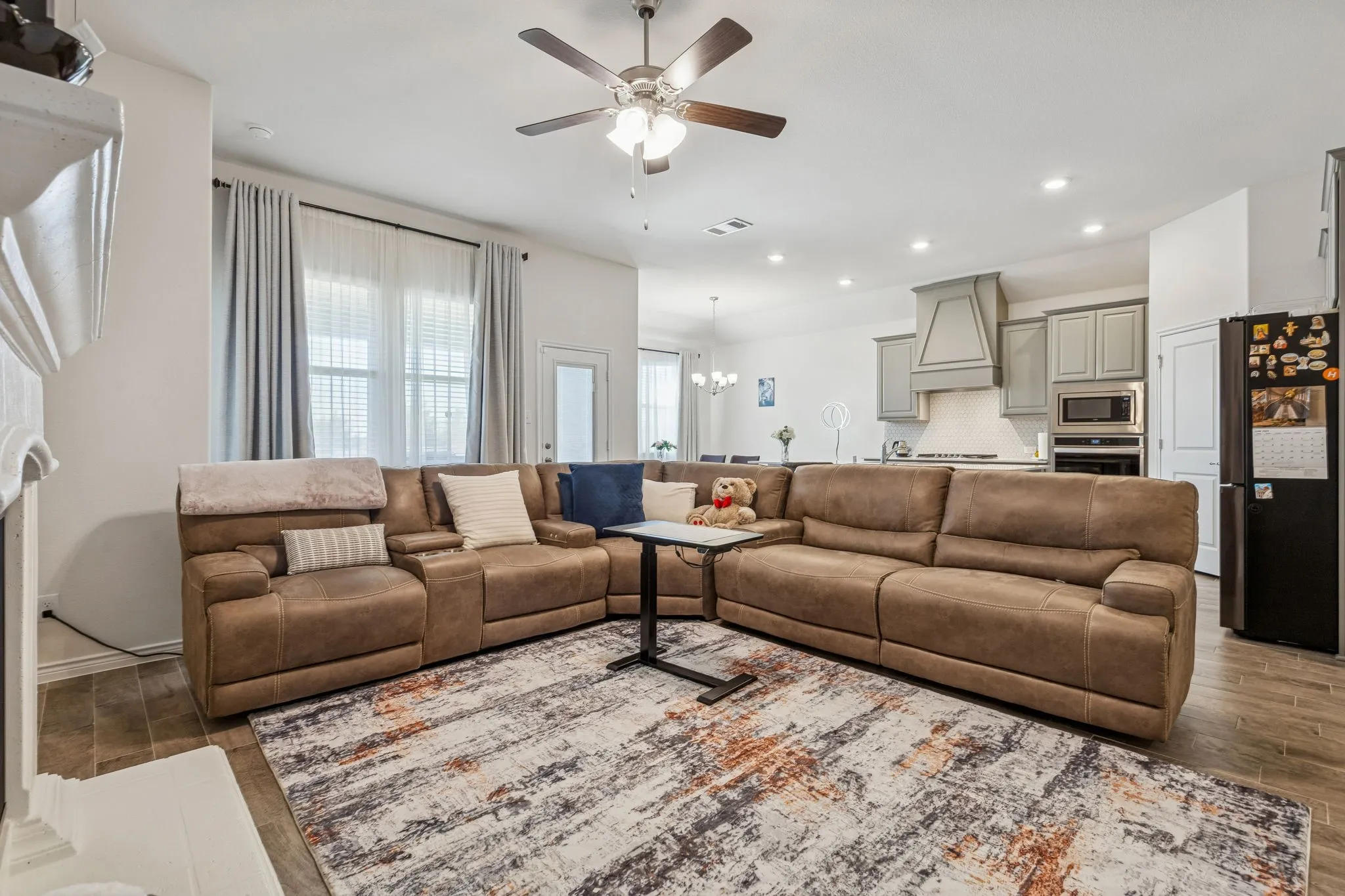 Living area featuring wood finish floors, a ceiling fan, and hanging lights