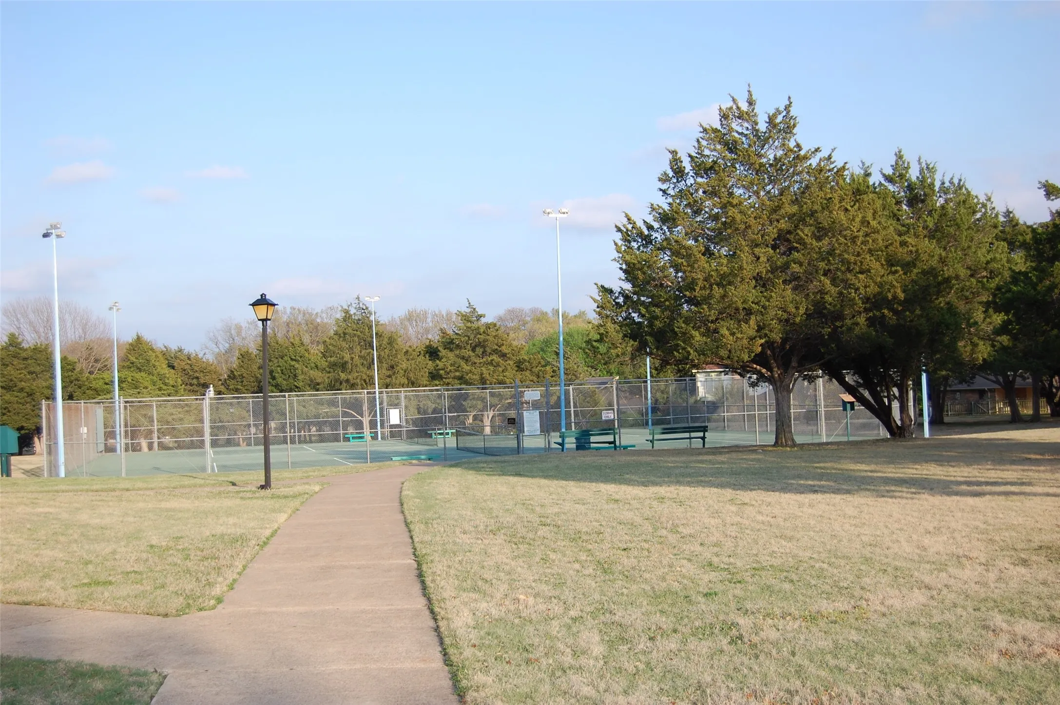 Two Lighted Fenced Tennis Courts