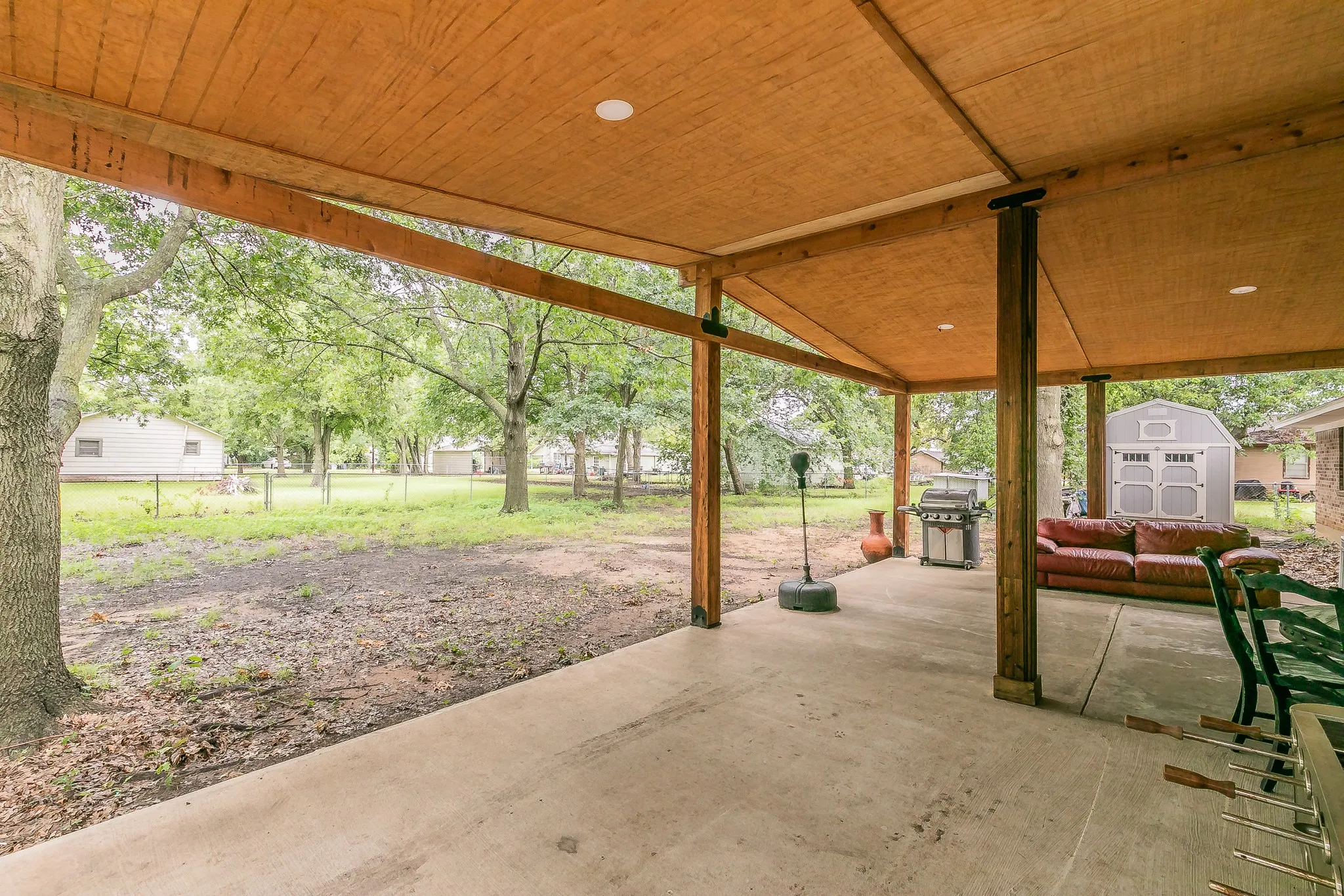 View of patio with a storage unit and grilling area