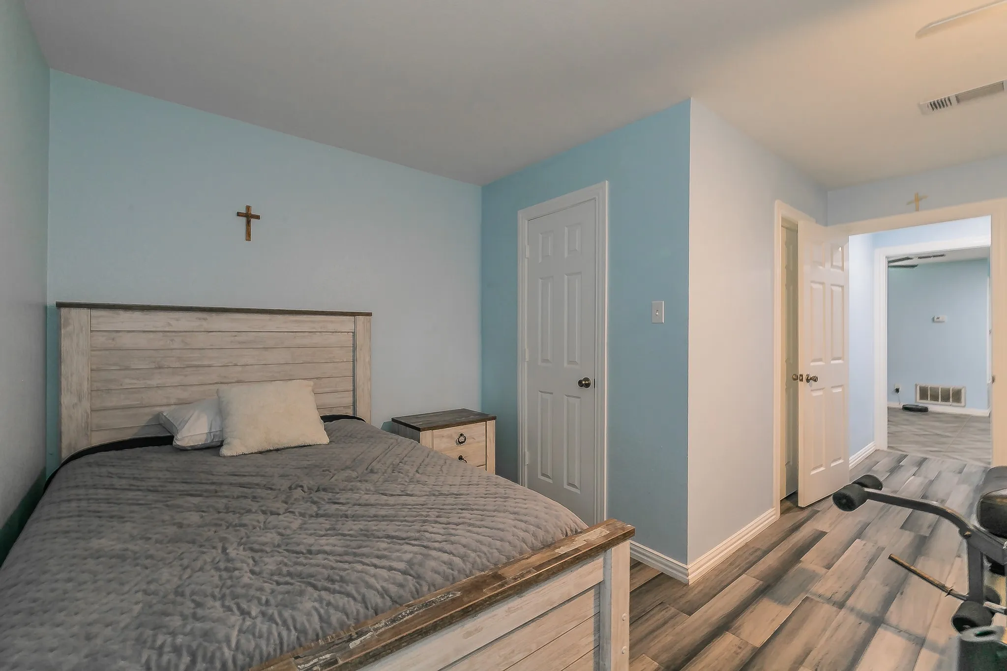 Bedroom with wood finished floors and baseboards