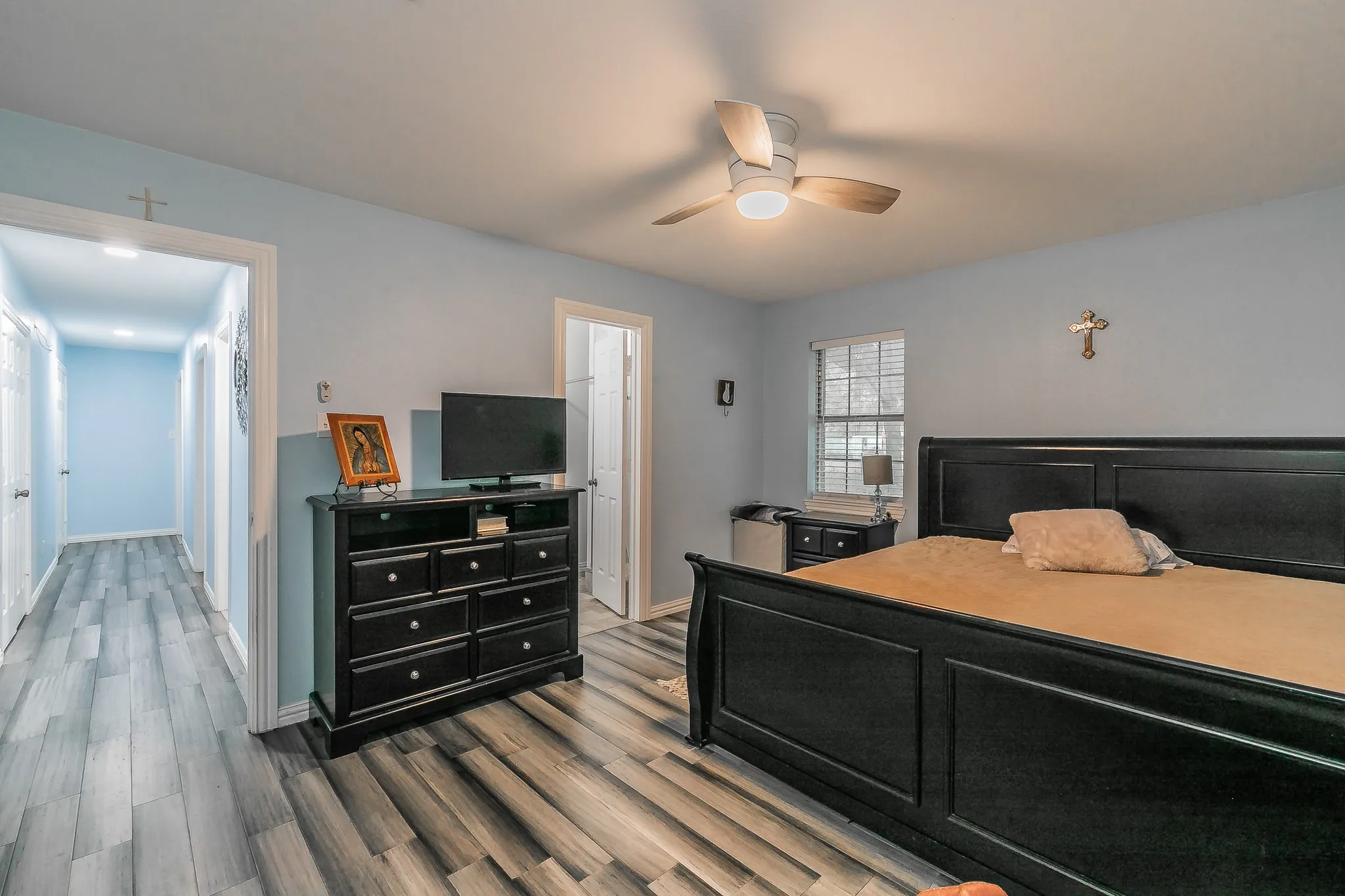 Bedroom featuring wood finished floors and ceiling fan
