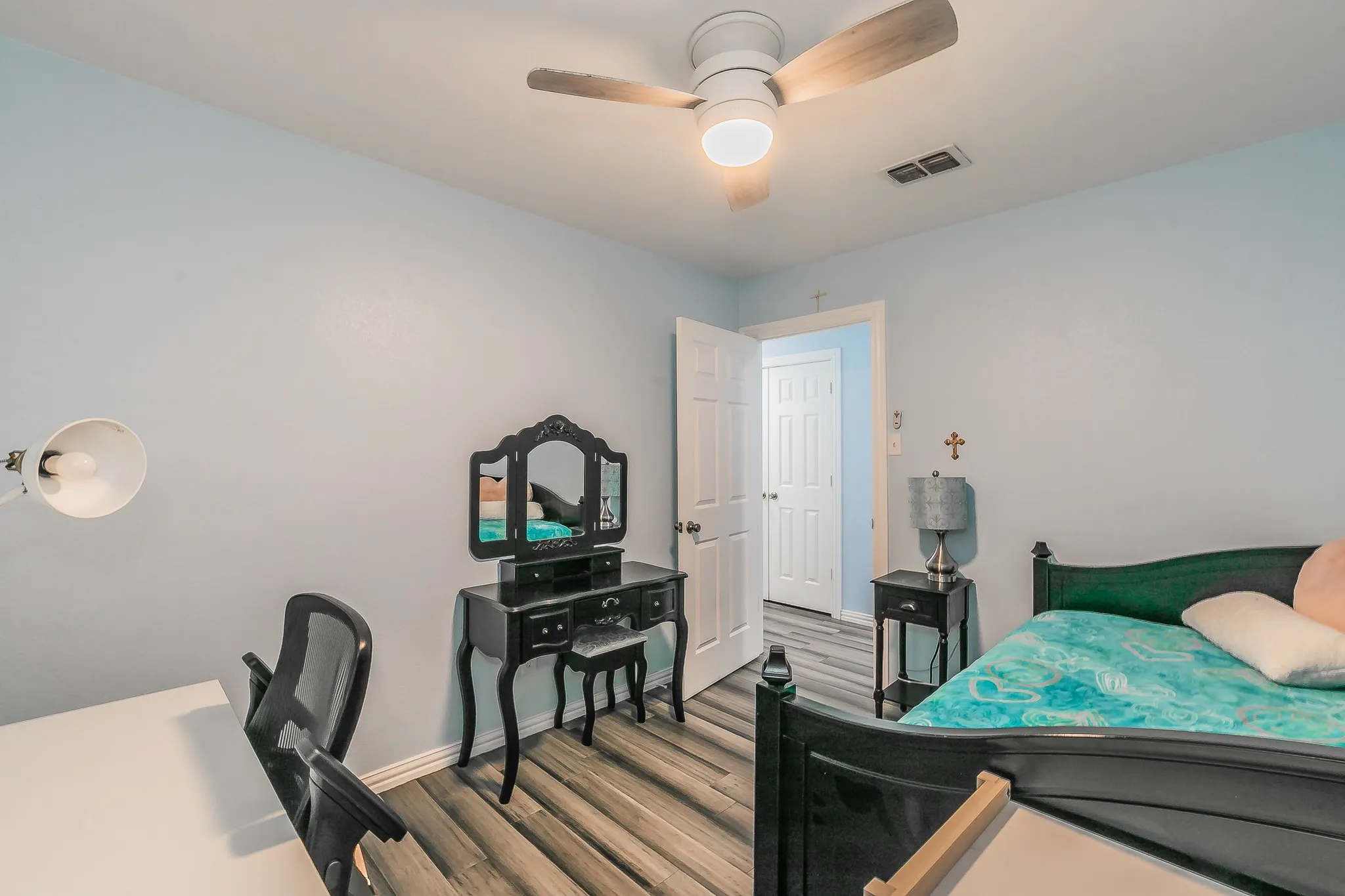 Bedroom featuring wood finished floors and a ceiling fan