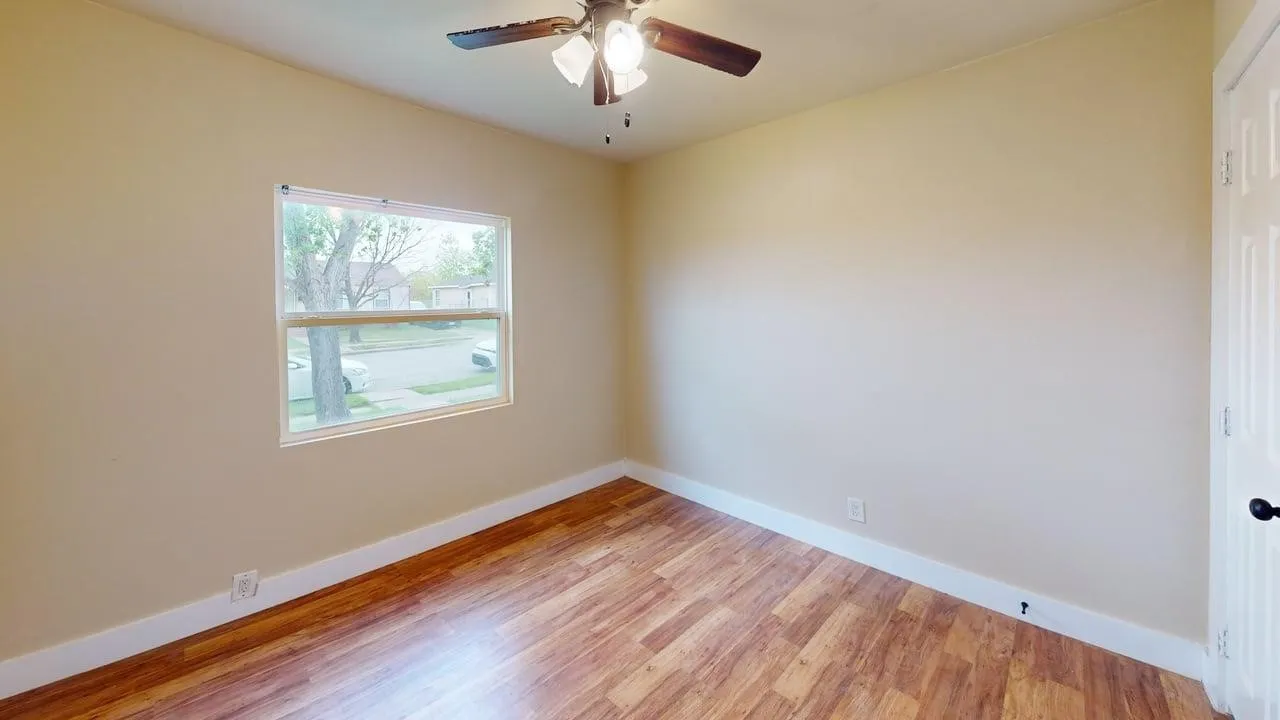 Spare room with light wood finished floors and a ceiling fan