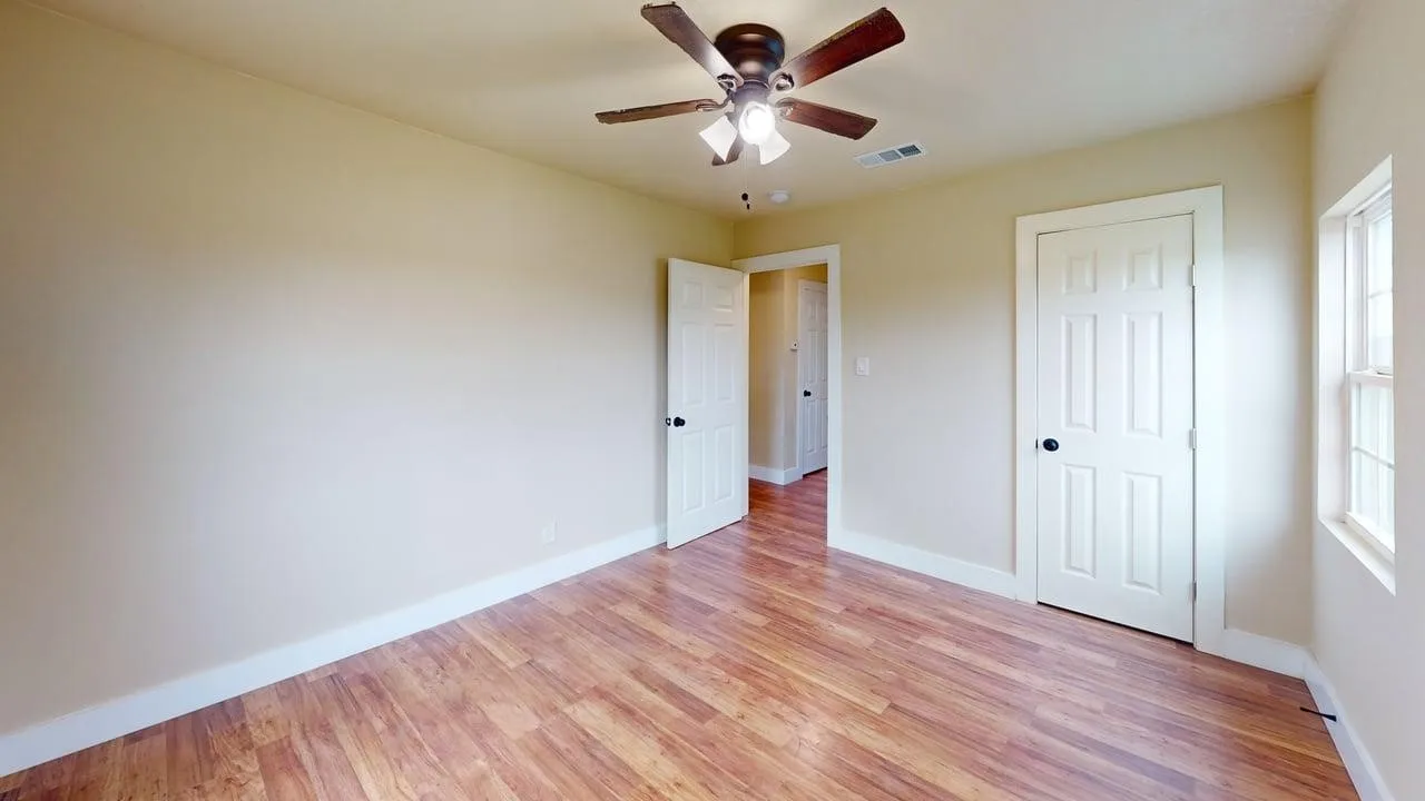 Unfurnished bedroom with light wood finished floors and a ceiling fan