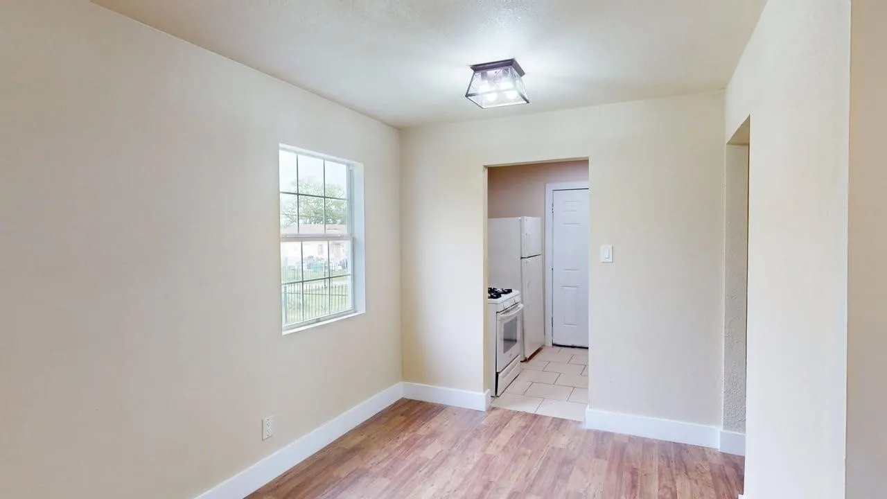 Unfurnished room featuring light wood-style floors and baseboards