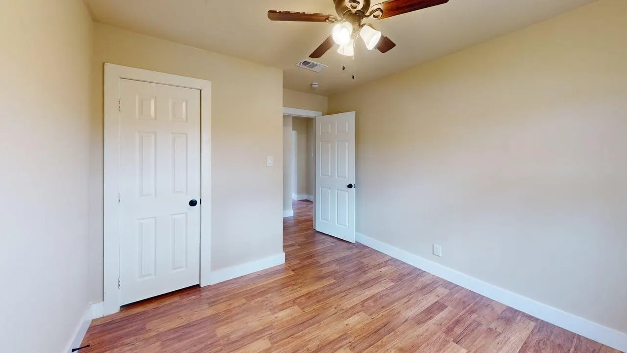 Unfurnished bedroom featuring light wood-style flooring and a ceiling fan