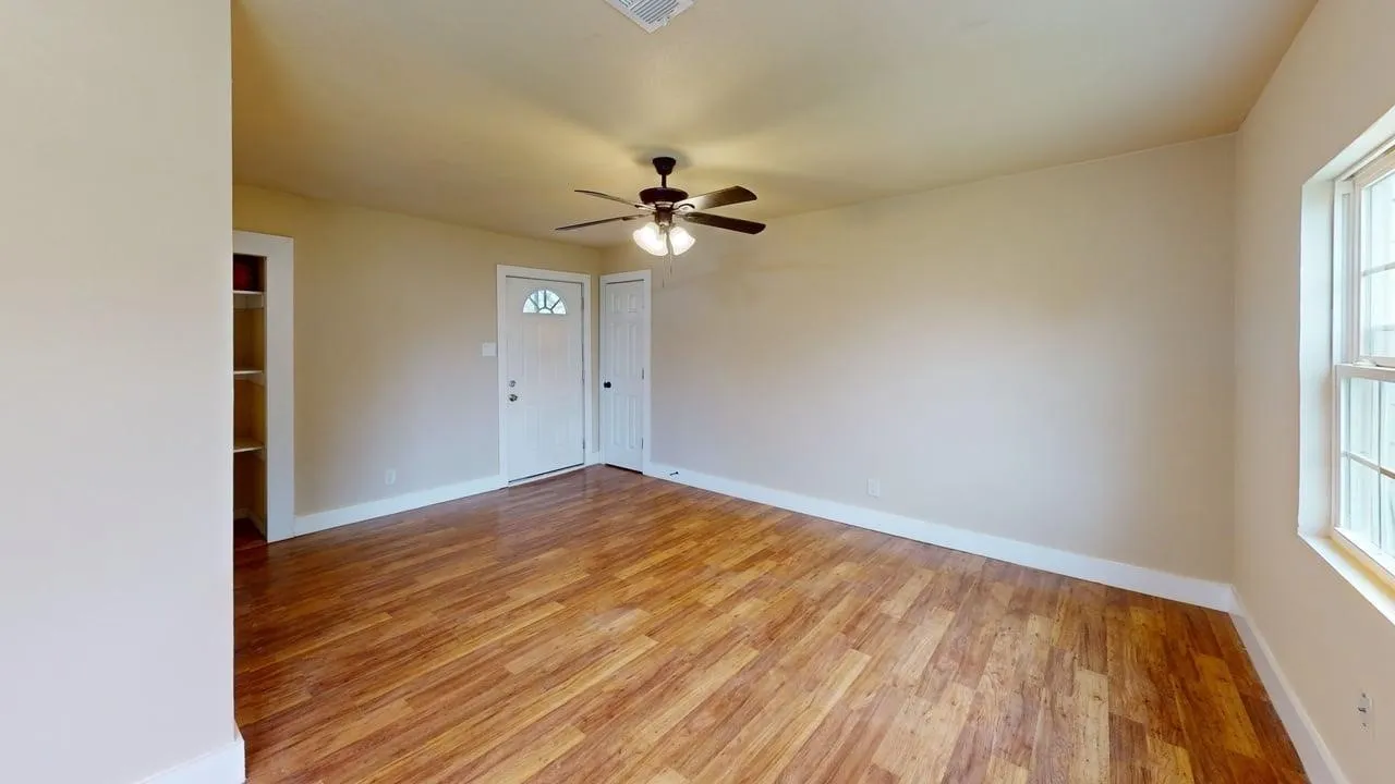 Spare room with light wood-type flooring and ceiling fan