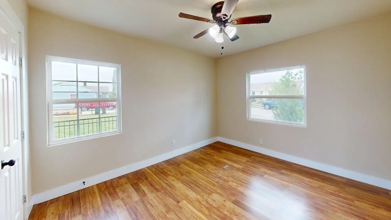 Unfurnished room with light wood-style floors and ceiling fan