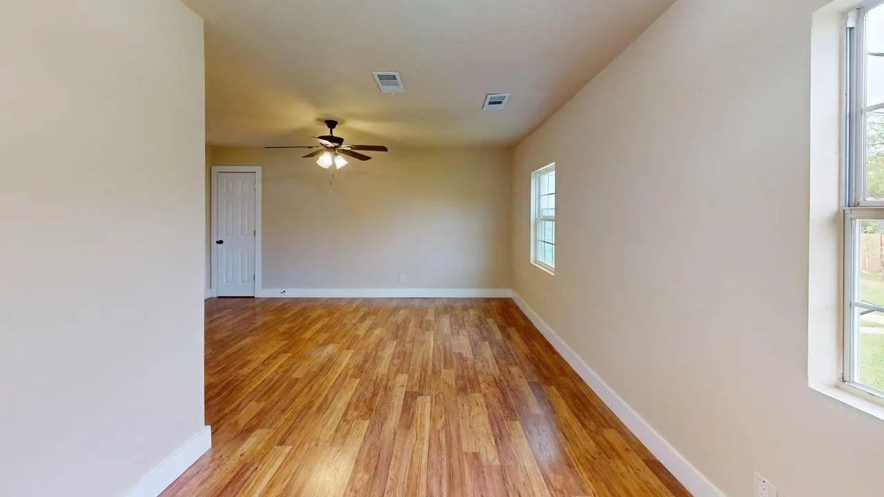 Spare room featuring light wood-type flooring and ceiling fan