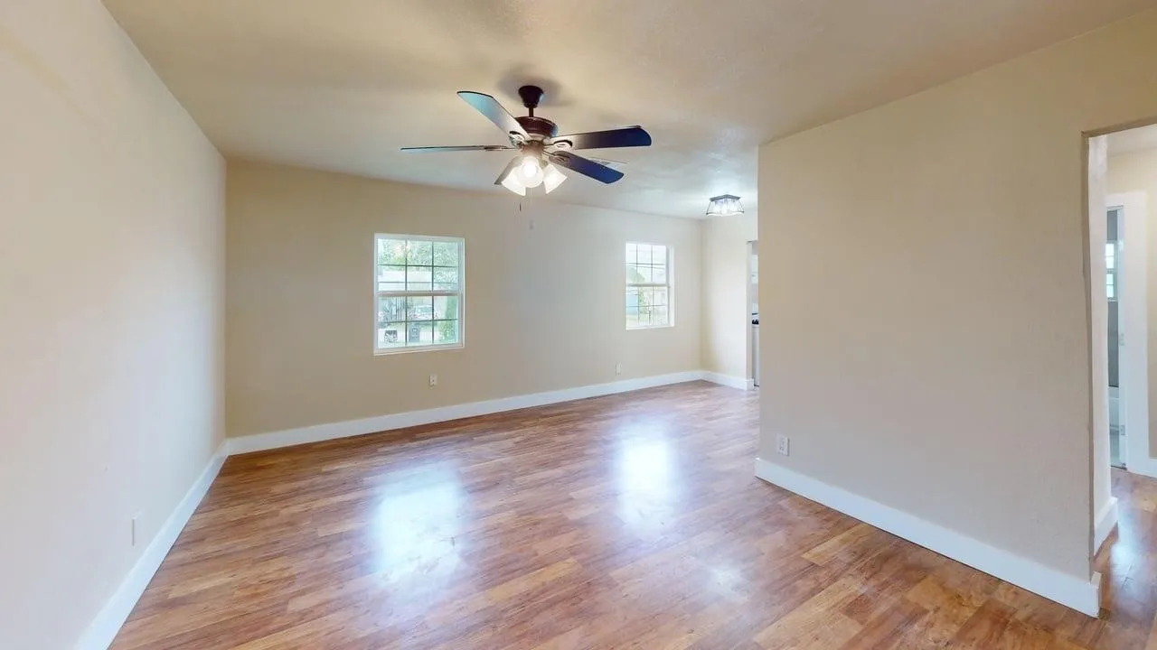 Empty room featuring a ceiling fan and light wood finished floors