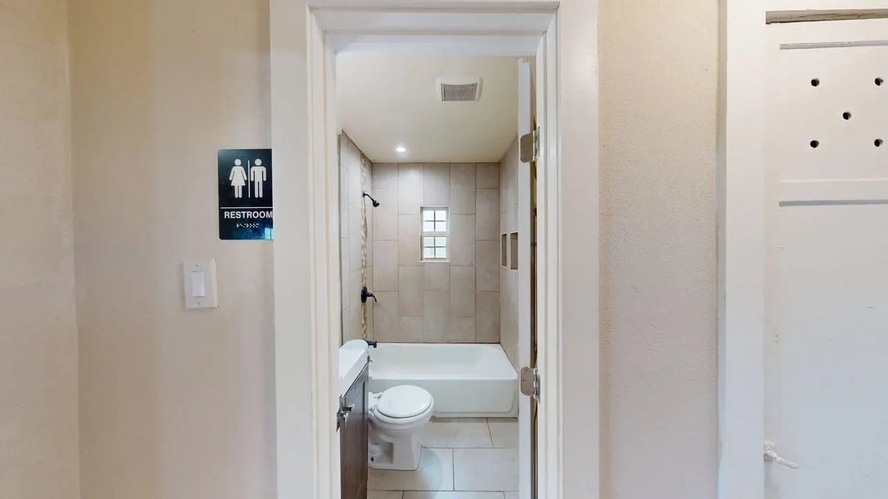 Full bathroom featuring vanity, light tile patterned floors, and shower / bathtub combination
