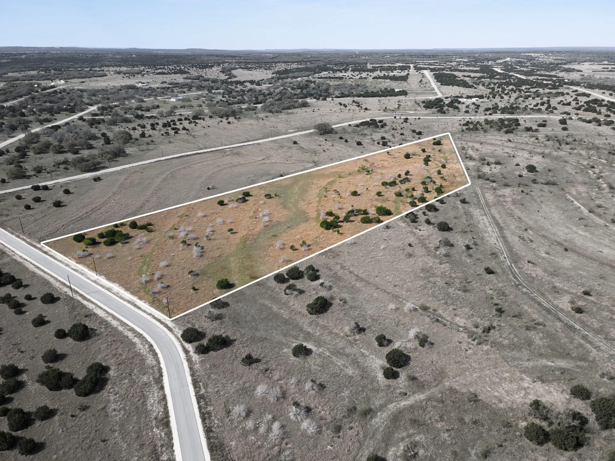 Aerial view of property and surrounding area featuring property boundaries highlighted and rural landscape