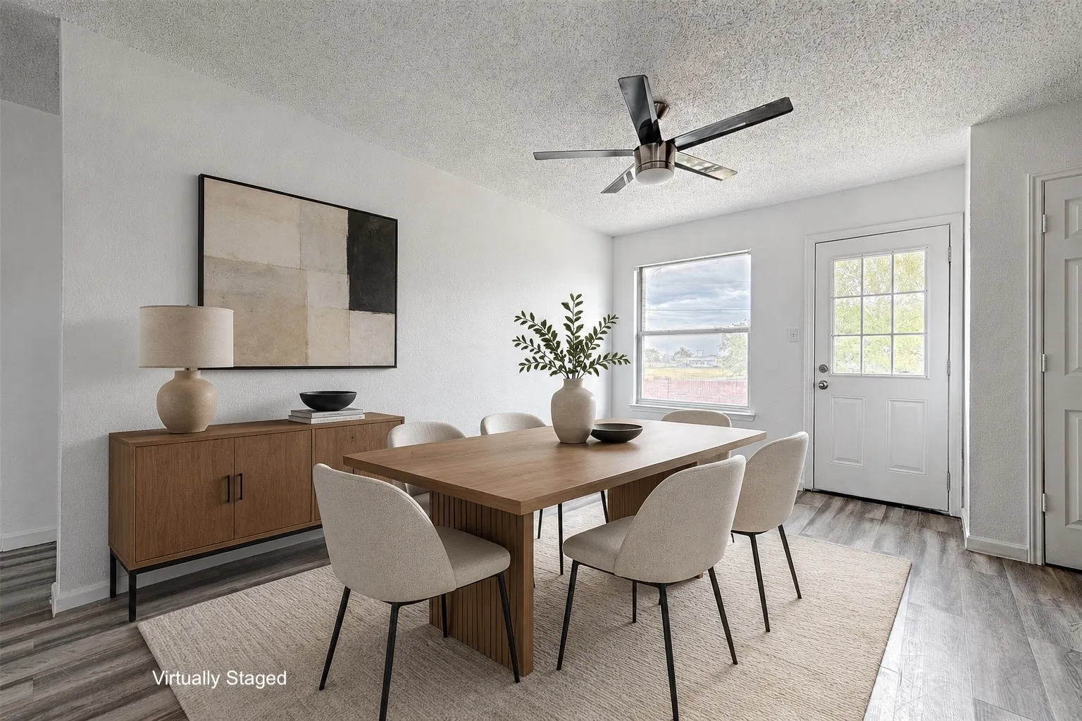 Dining area featuring wood-finish flooring, a contemporary ceiling fan, and white walls