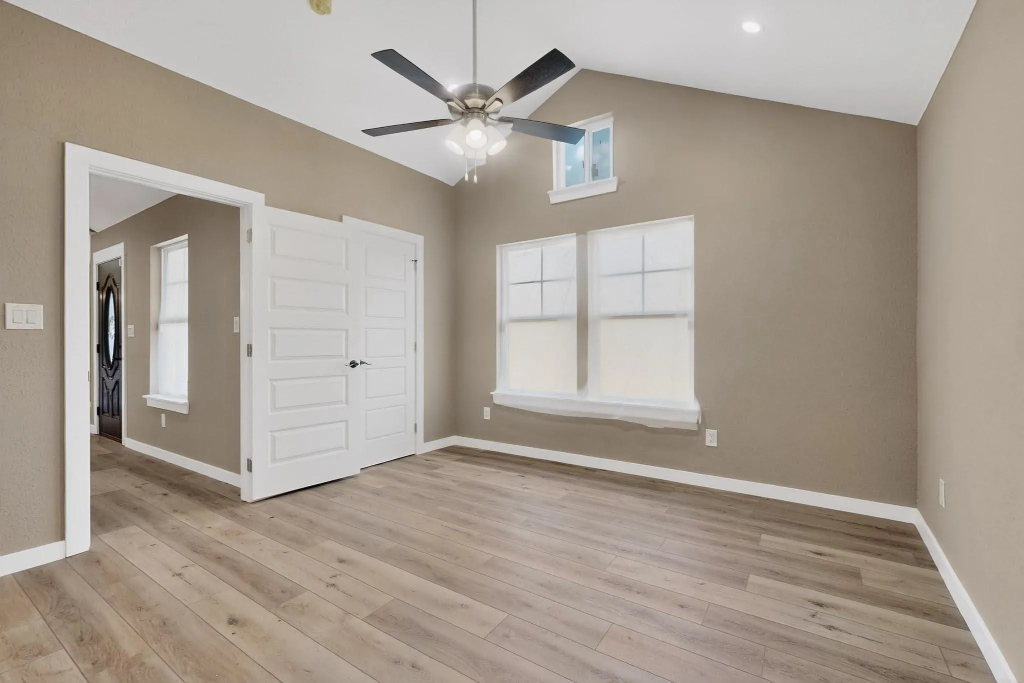 Unfurnished bedroom with a ceiling fan and light wood-style flooring