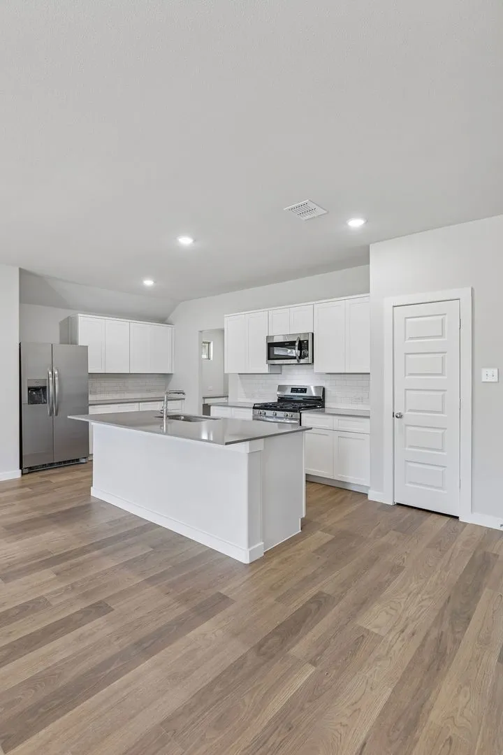 Kitchen in the Harrison home plan by Trophy Signature Homes – REPRESENTATIVE PHOTO