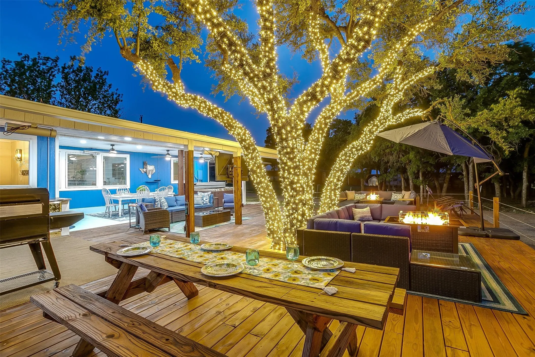 Deck at twilight featuring outdoor lounge area and a fire pit