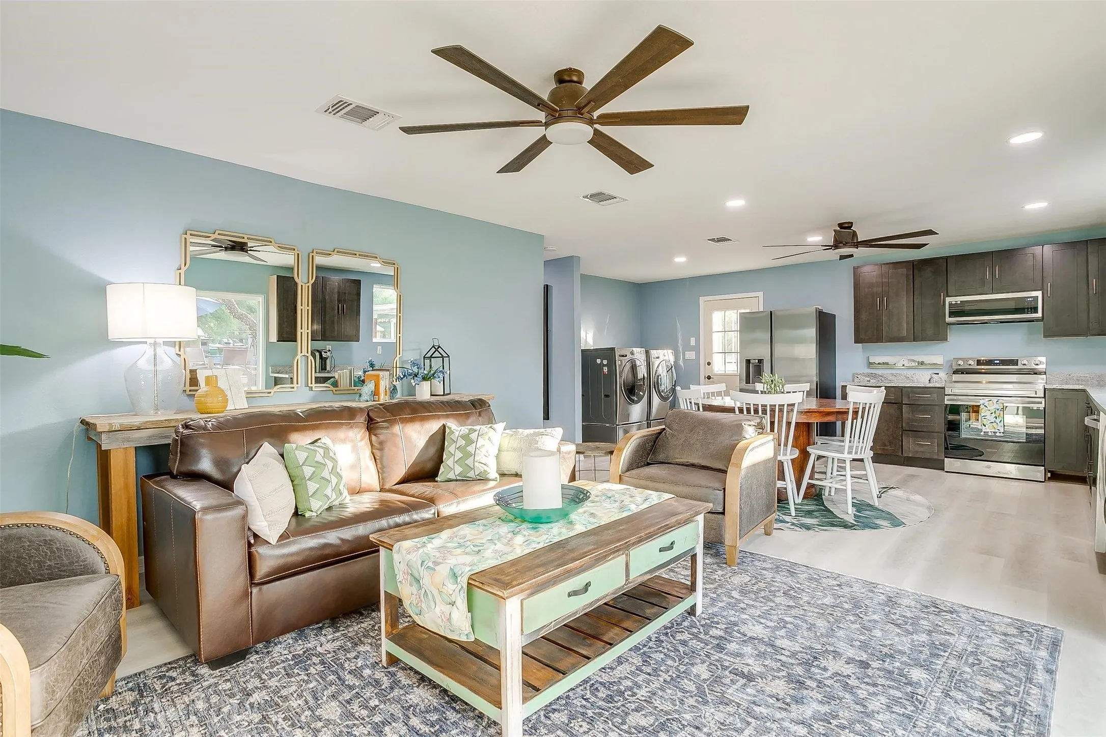 Guest Living room with washing machine and clothes dryer, ceiling fan, recessed lighting, and light wood-style flooring