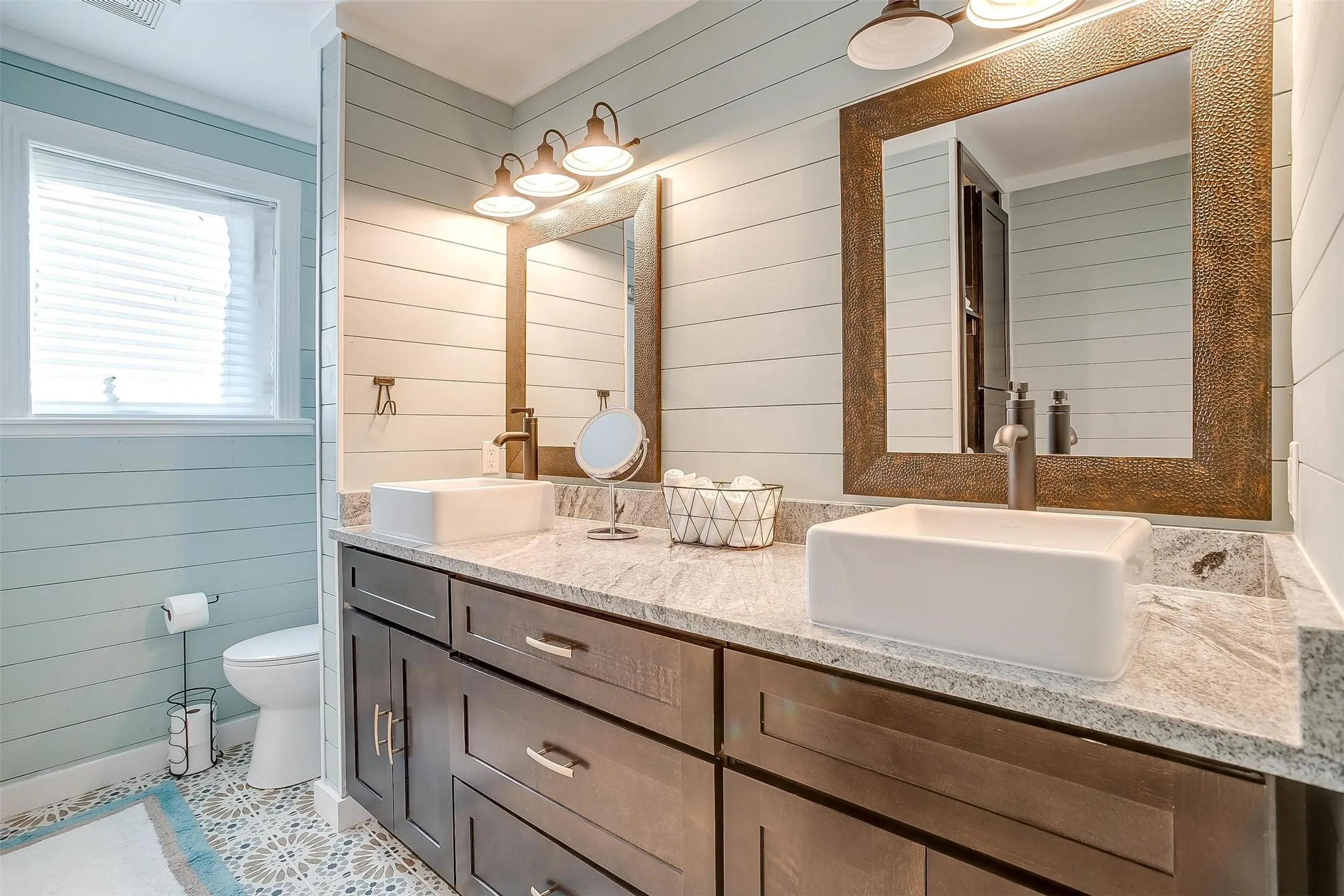 Full bath with wooden walls and double vanity