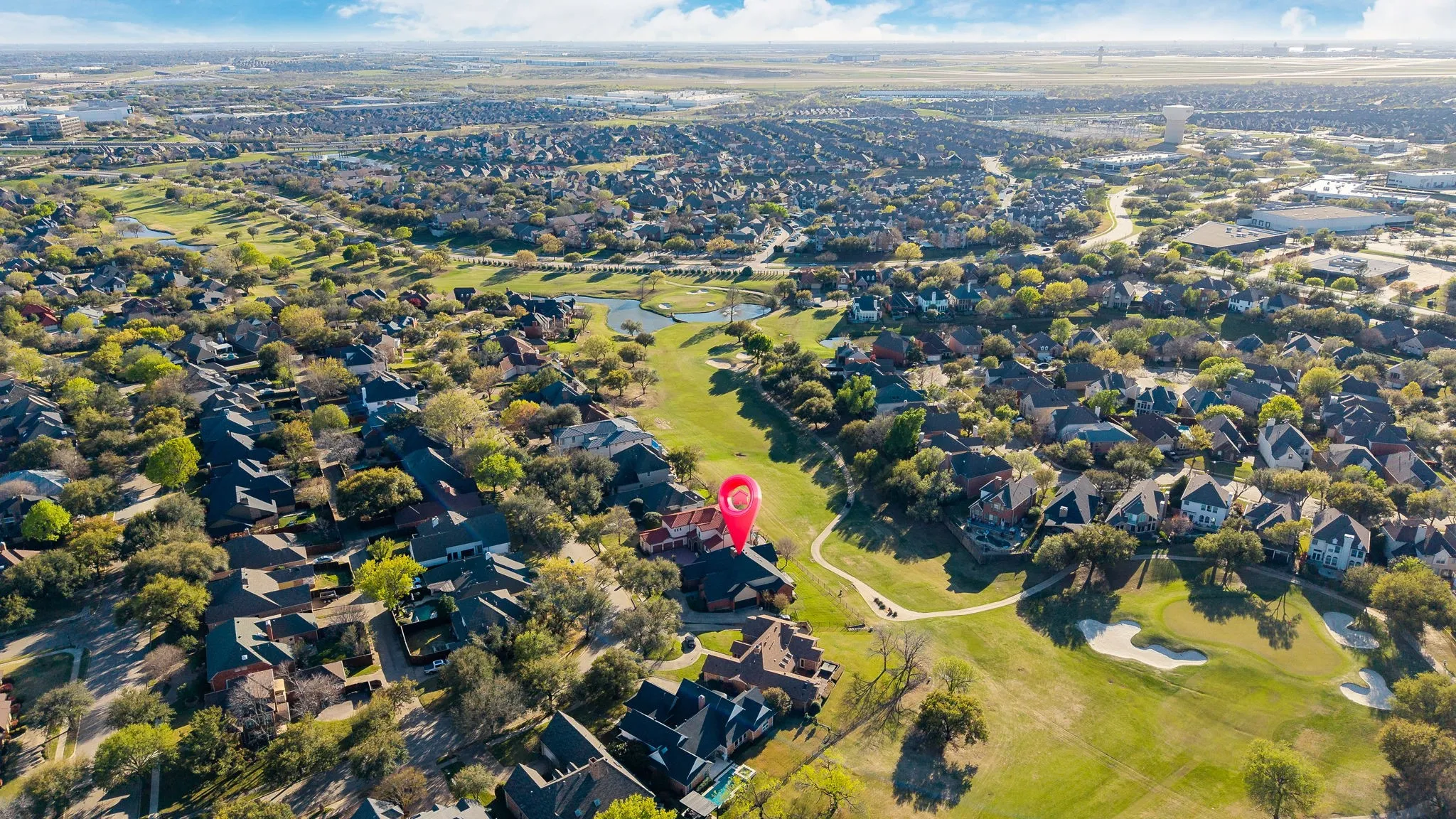 Aerial view of property's location with nearby suburban area and a golf course