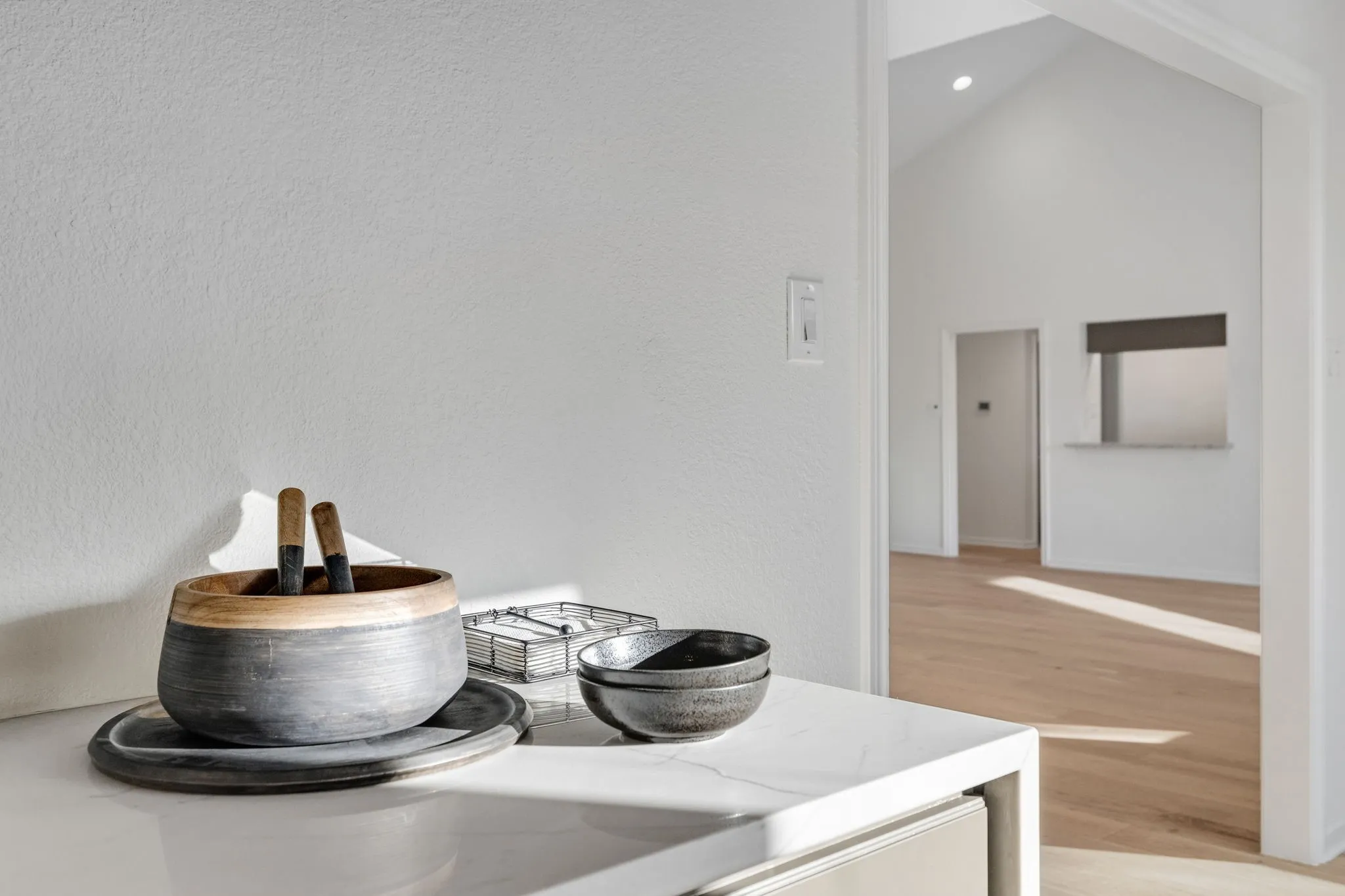 Detailed view of wood finished floors and recessed lighting