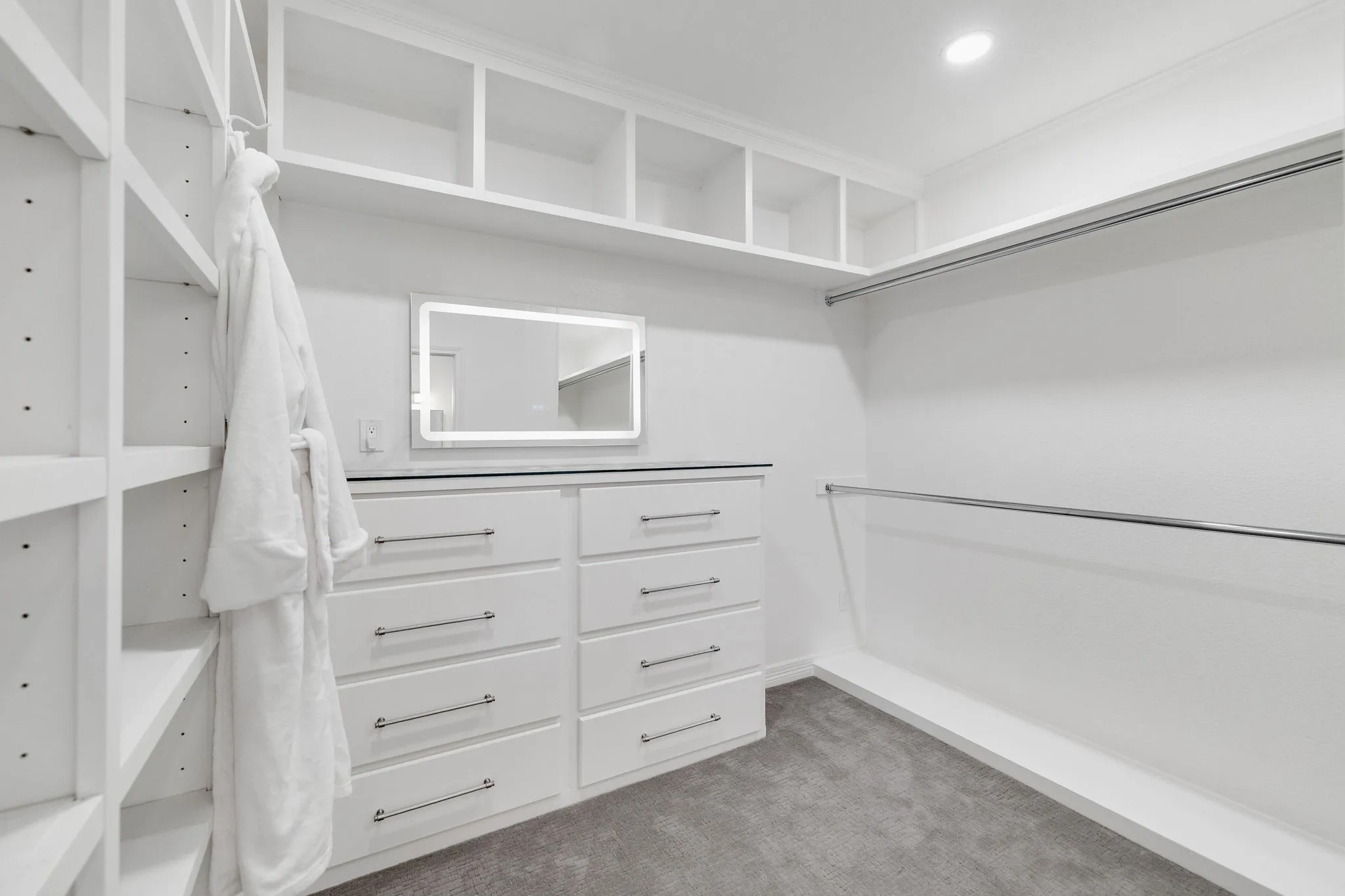 Walk in closet featuring dark colored carpet