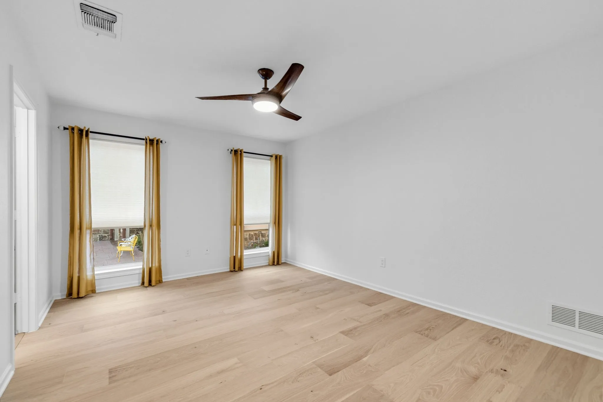 Spare room featuring light wood-style flooring and a ceiling fan