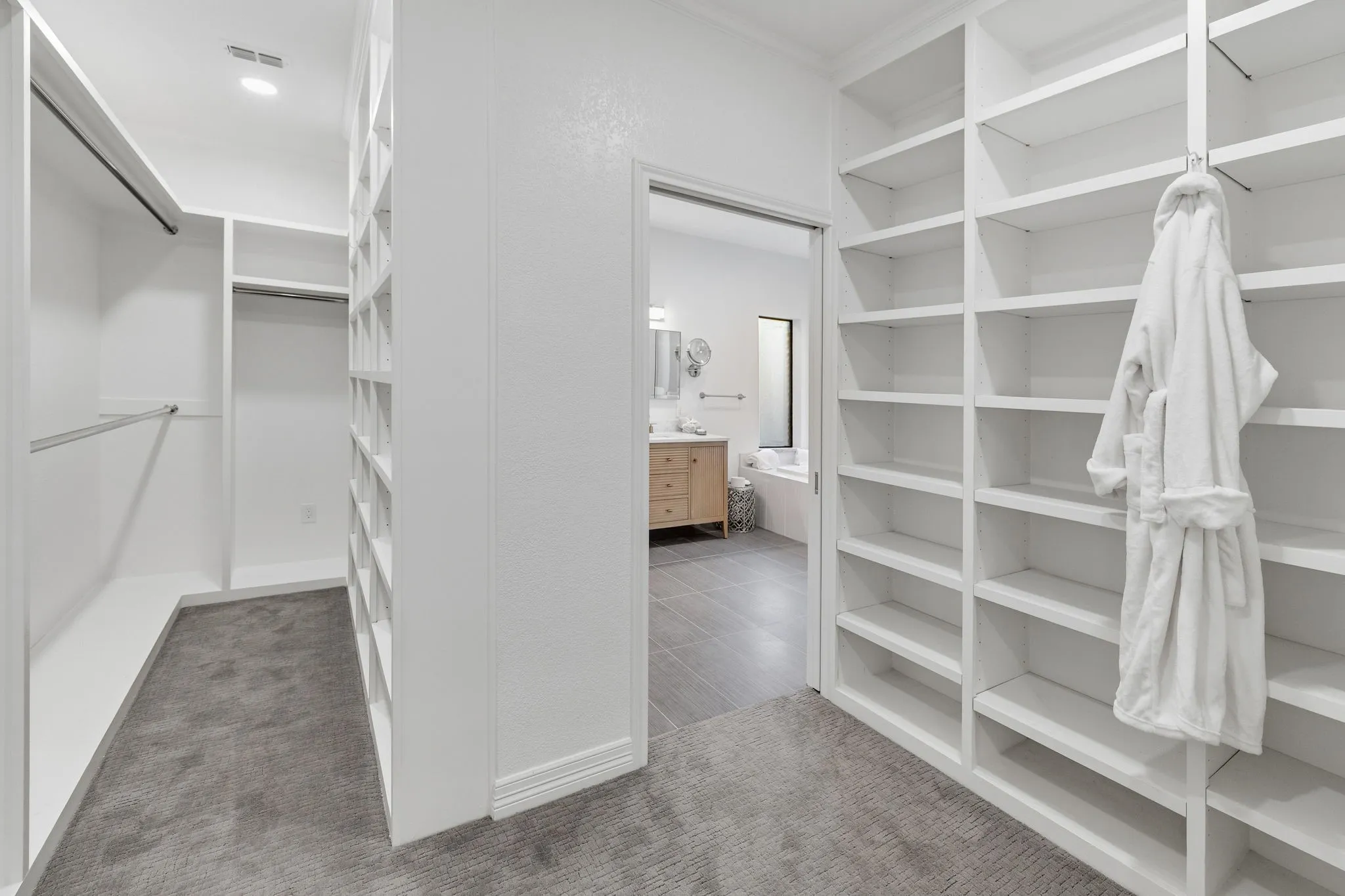 Walk in closet featuring light carpet
