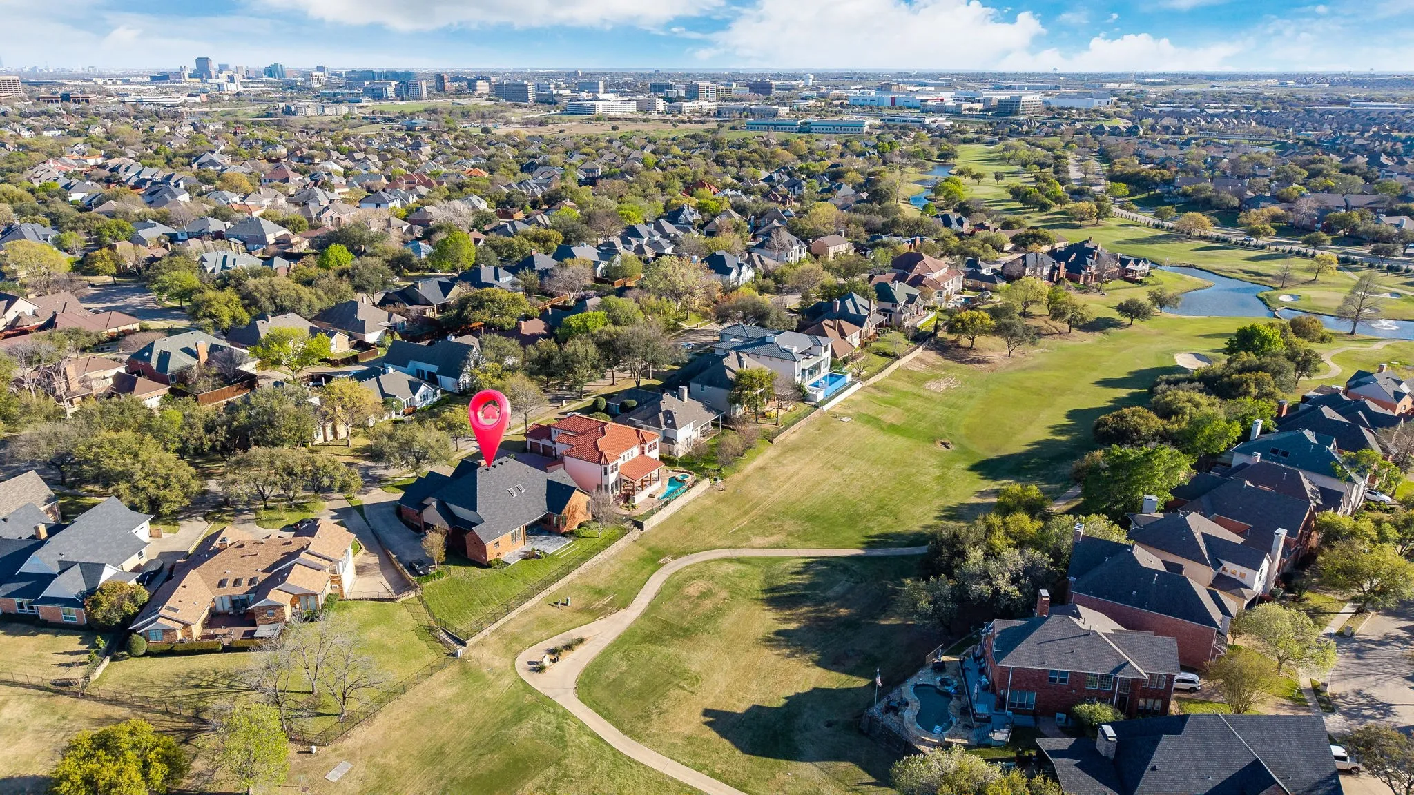 Aerial view of property's location with nearby suburban area