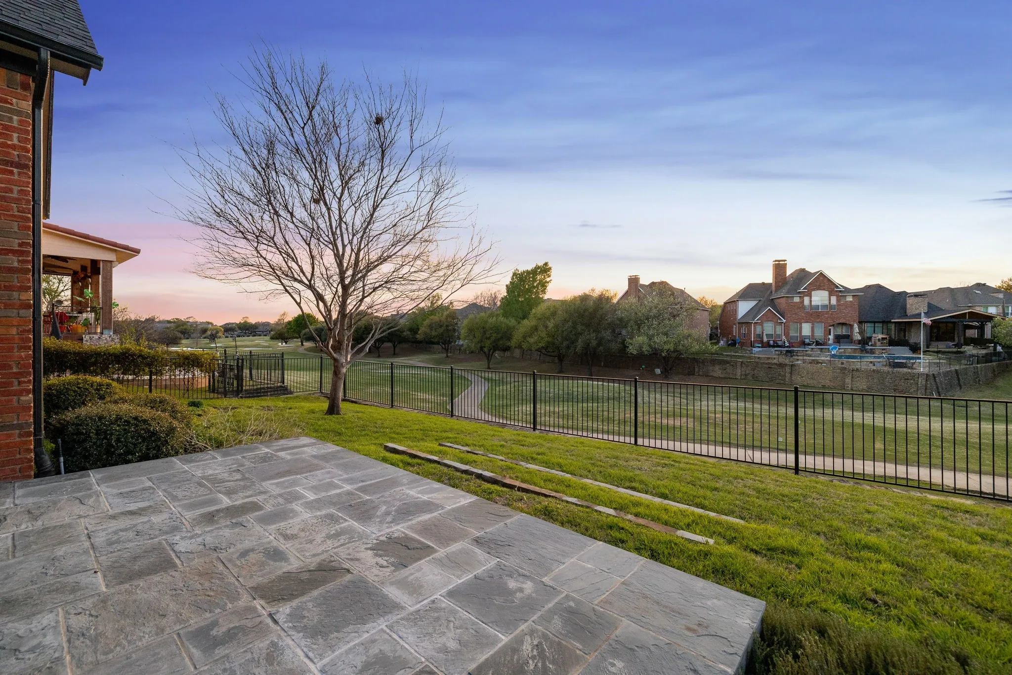 Fenced backyard with a patio area