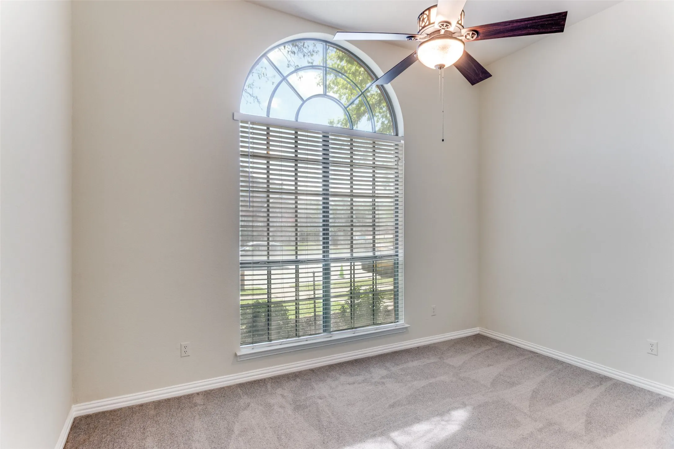 Bedroom #2 with ceiling fan, large closet, and light carpet