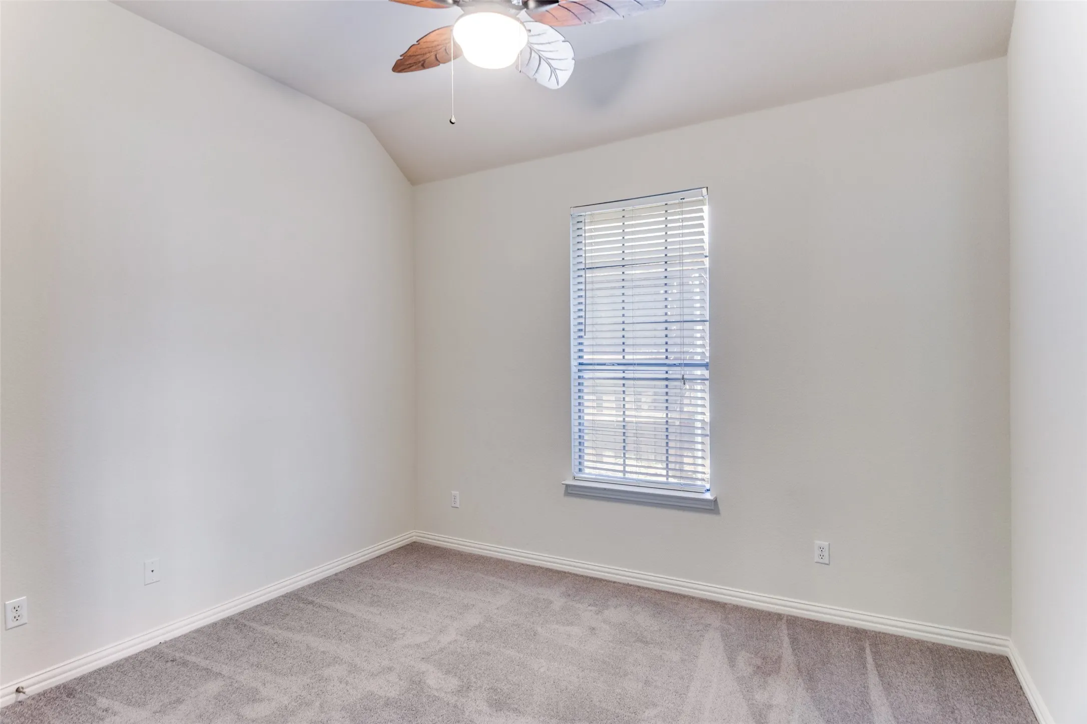 Bedroom #4 featuring light carpet, large closet, ceiling fan, and lofted ceiling
