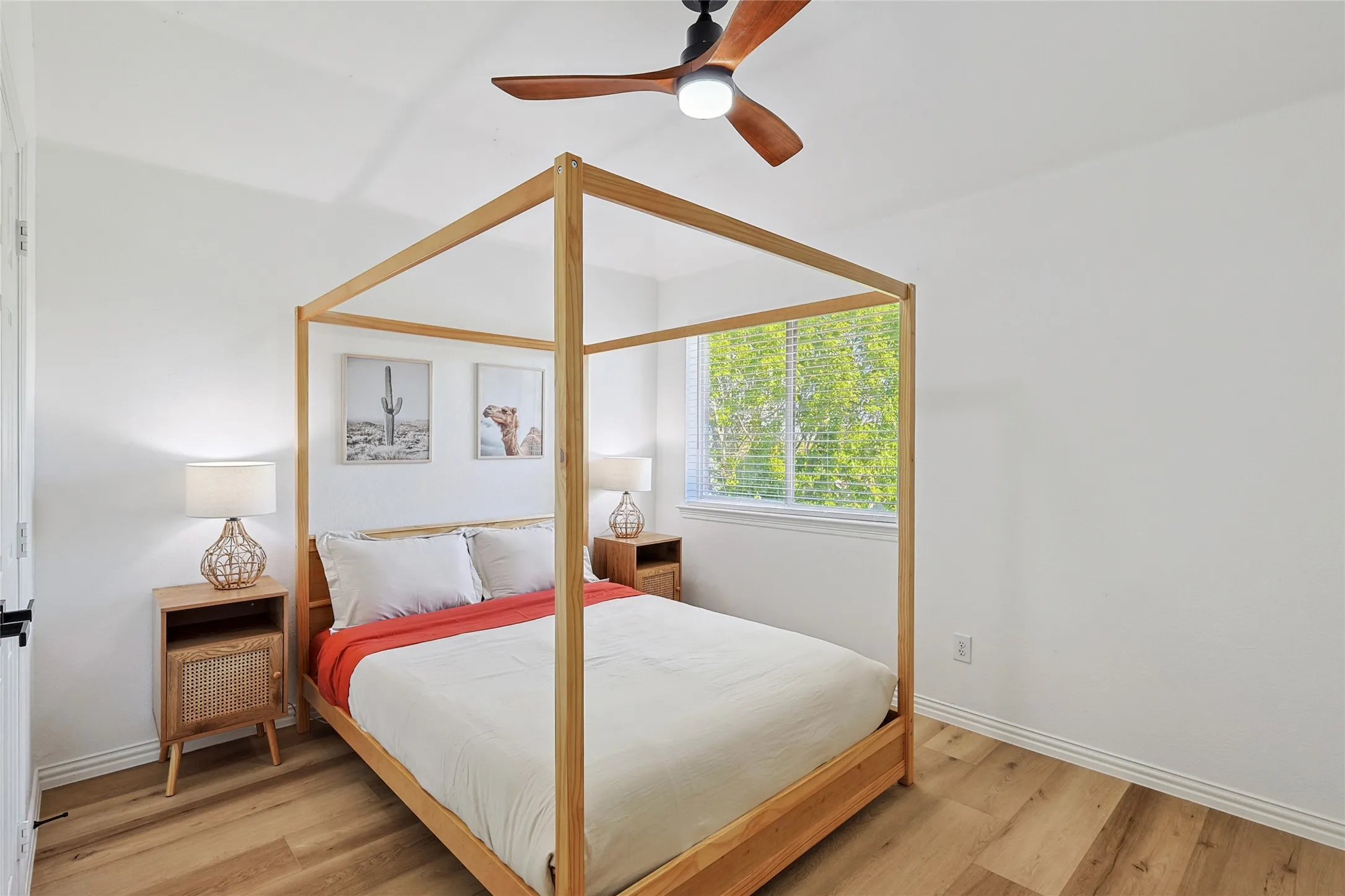 Bedroom with ceiling fan and light wood-type flooring