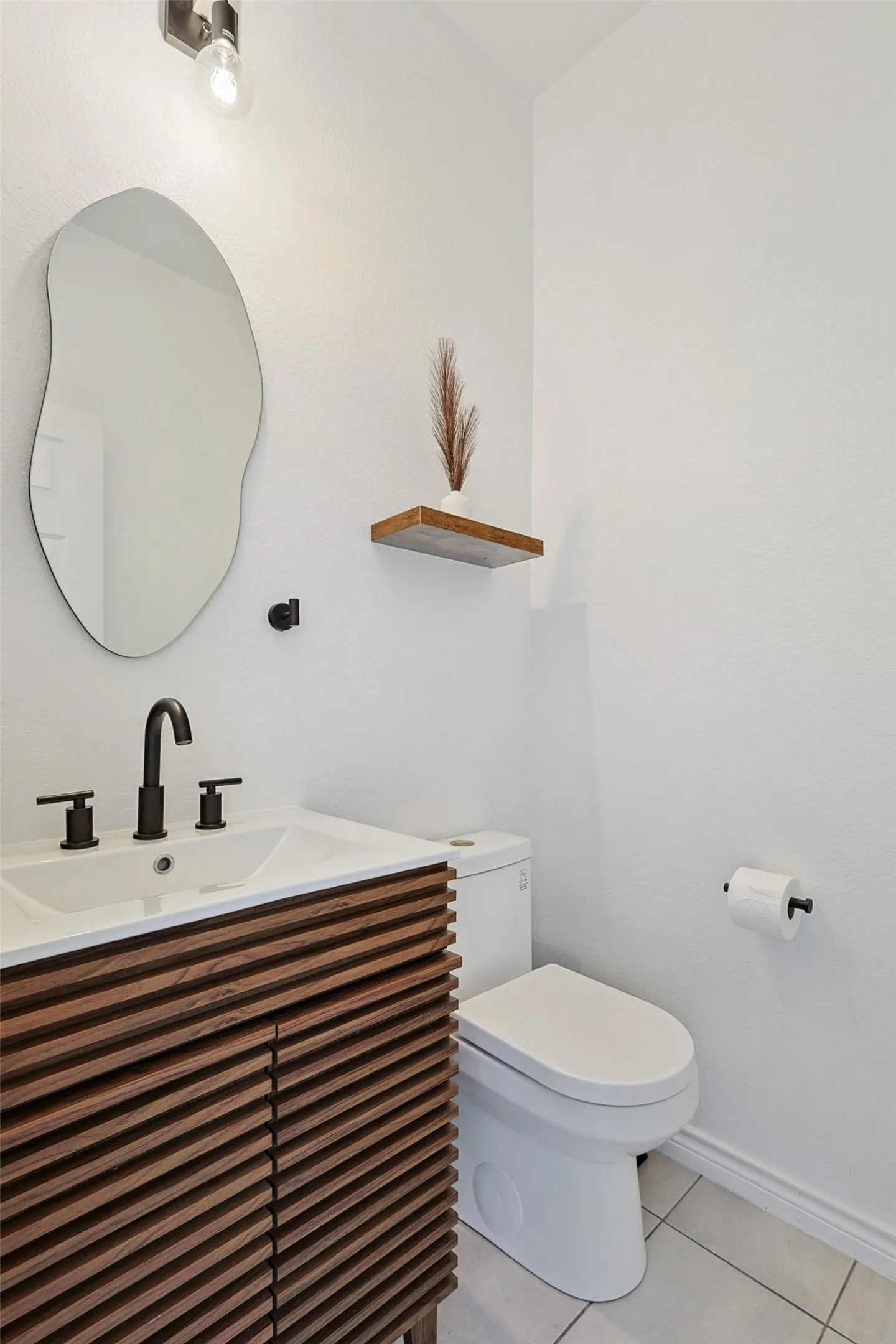 Bathroom featuring tile floors, toilet, and vanity