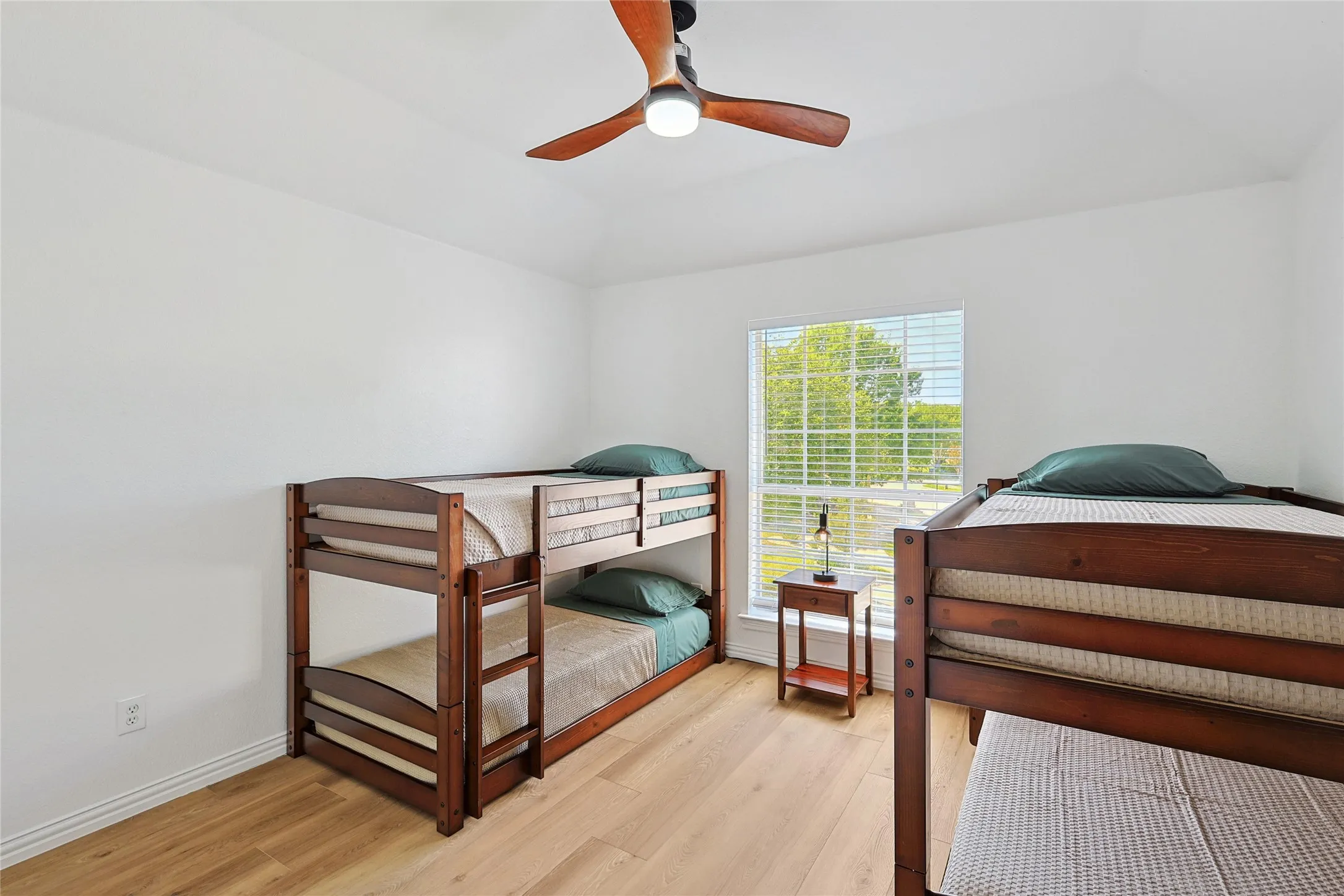 Bedroom with ceiling fan and light hardwood / wood-style flooring