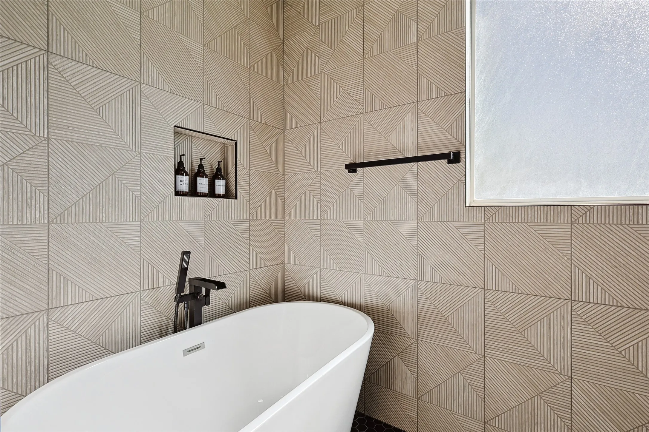Bathroom with tile walls and a bathing tub