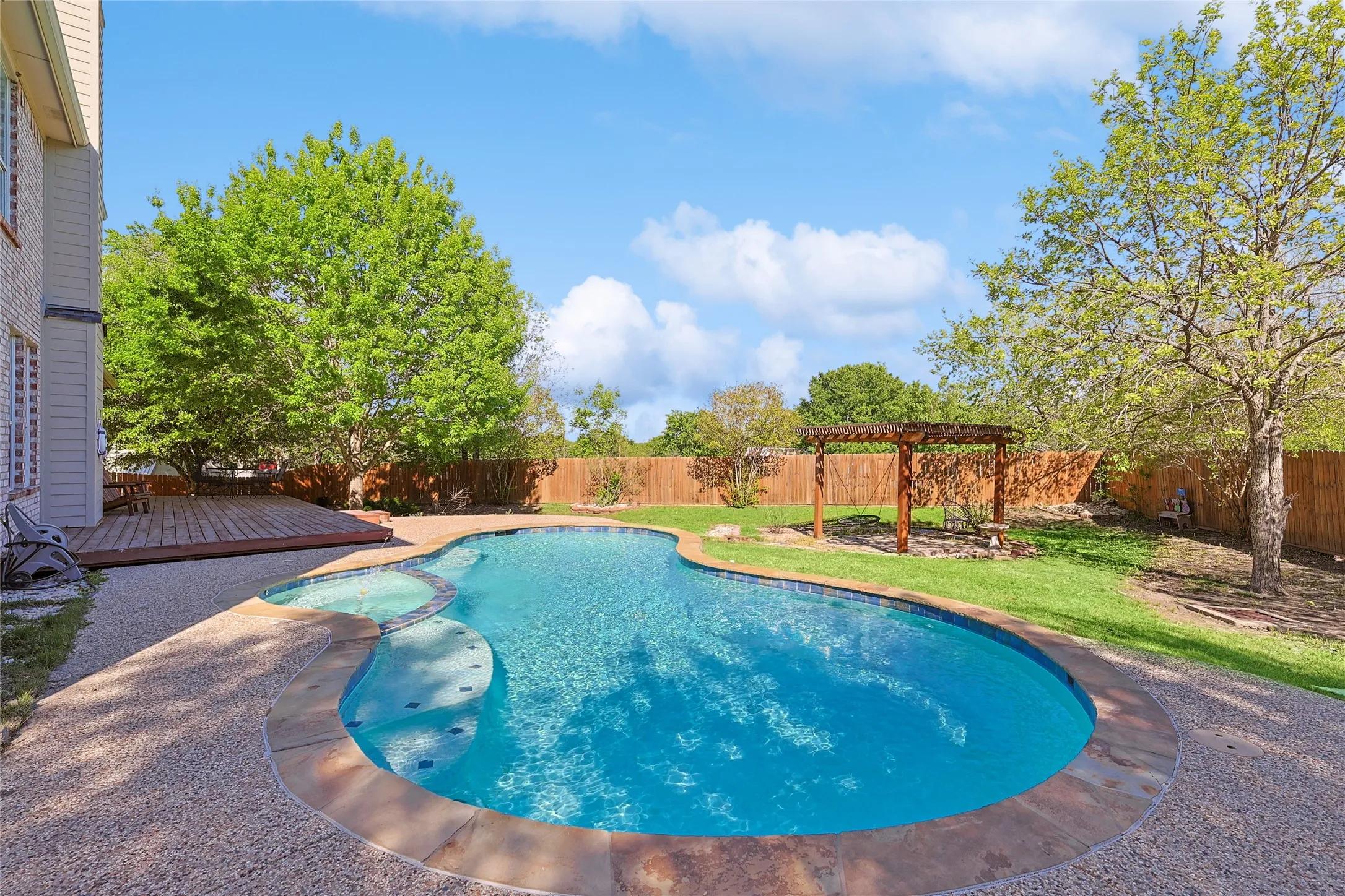 View of pool featuring a wooden deck