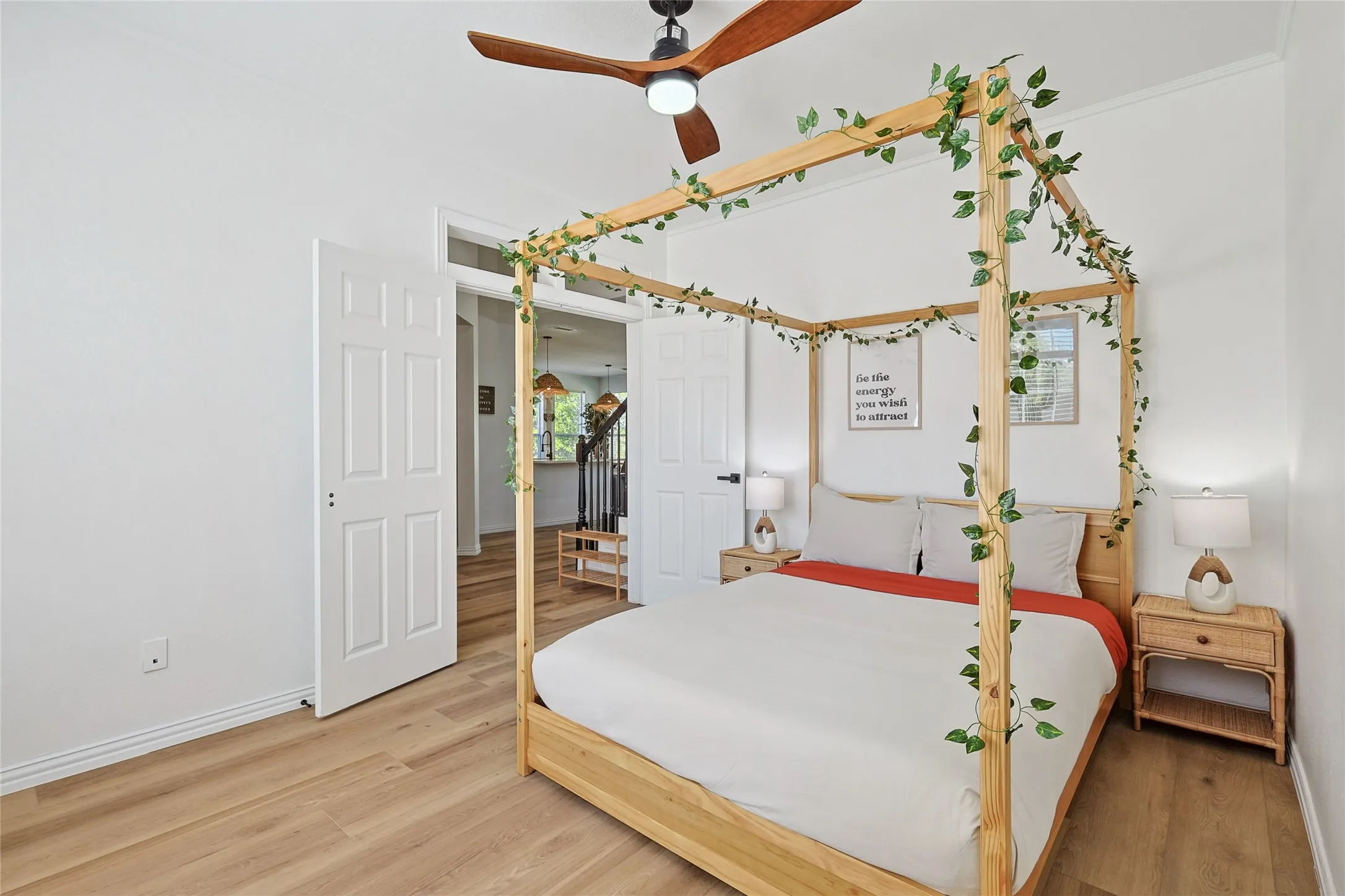 Bedroom featuring multiple windows, hardwood / wood-style floors, ceiling fan, and crown molding