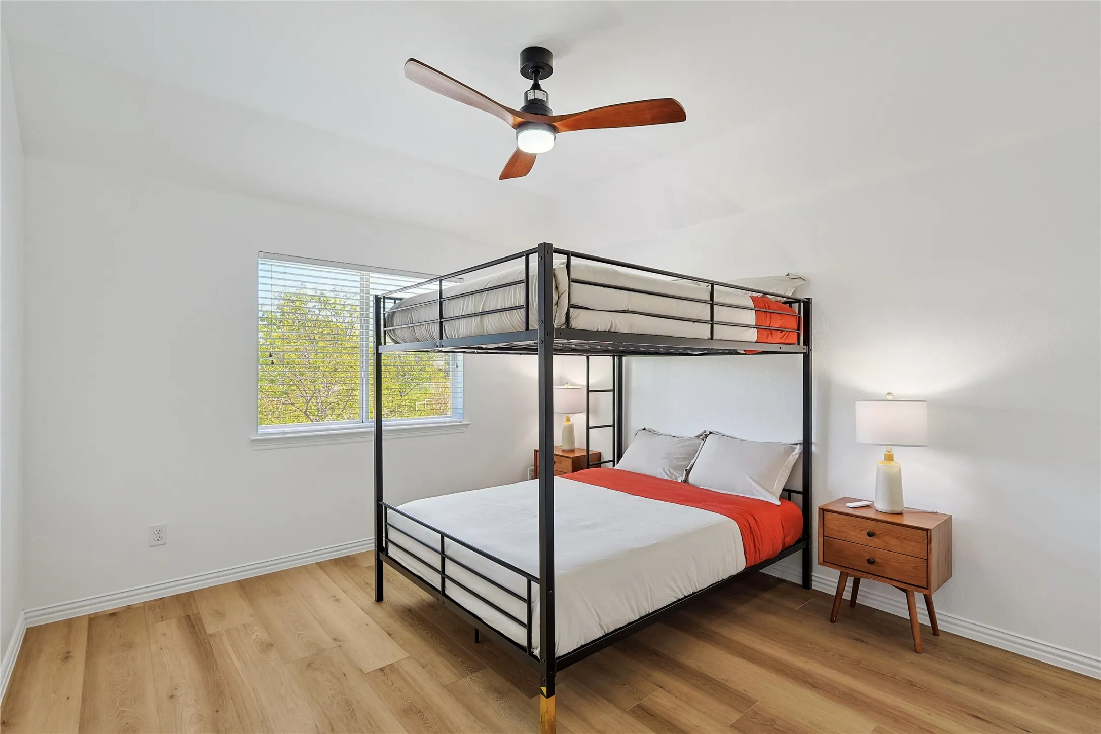 Bedroom with ceiling fan and wood-type flooring