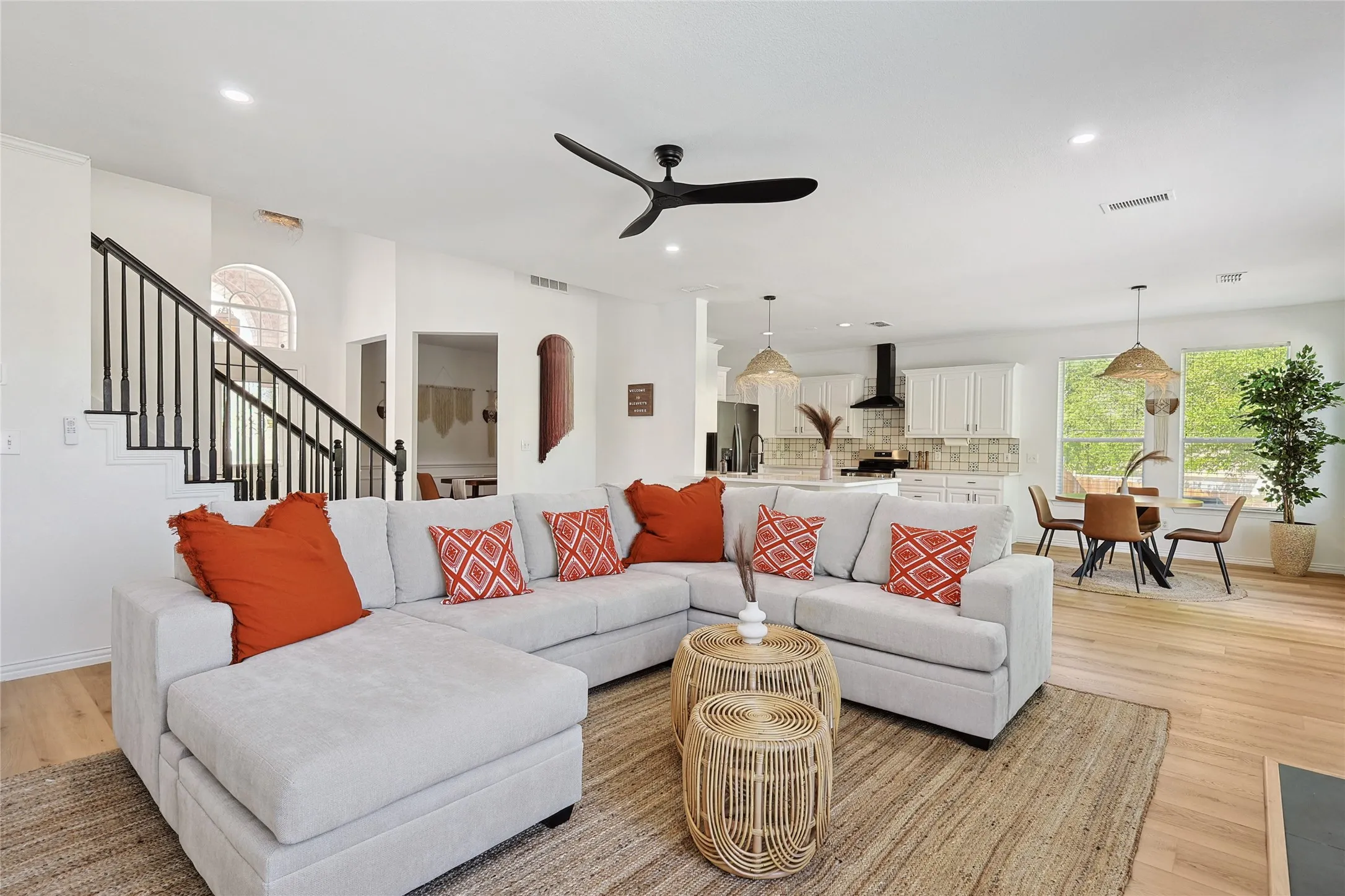 Living room with light wood-type flooring and ceiling fan