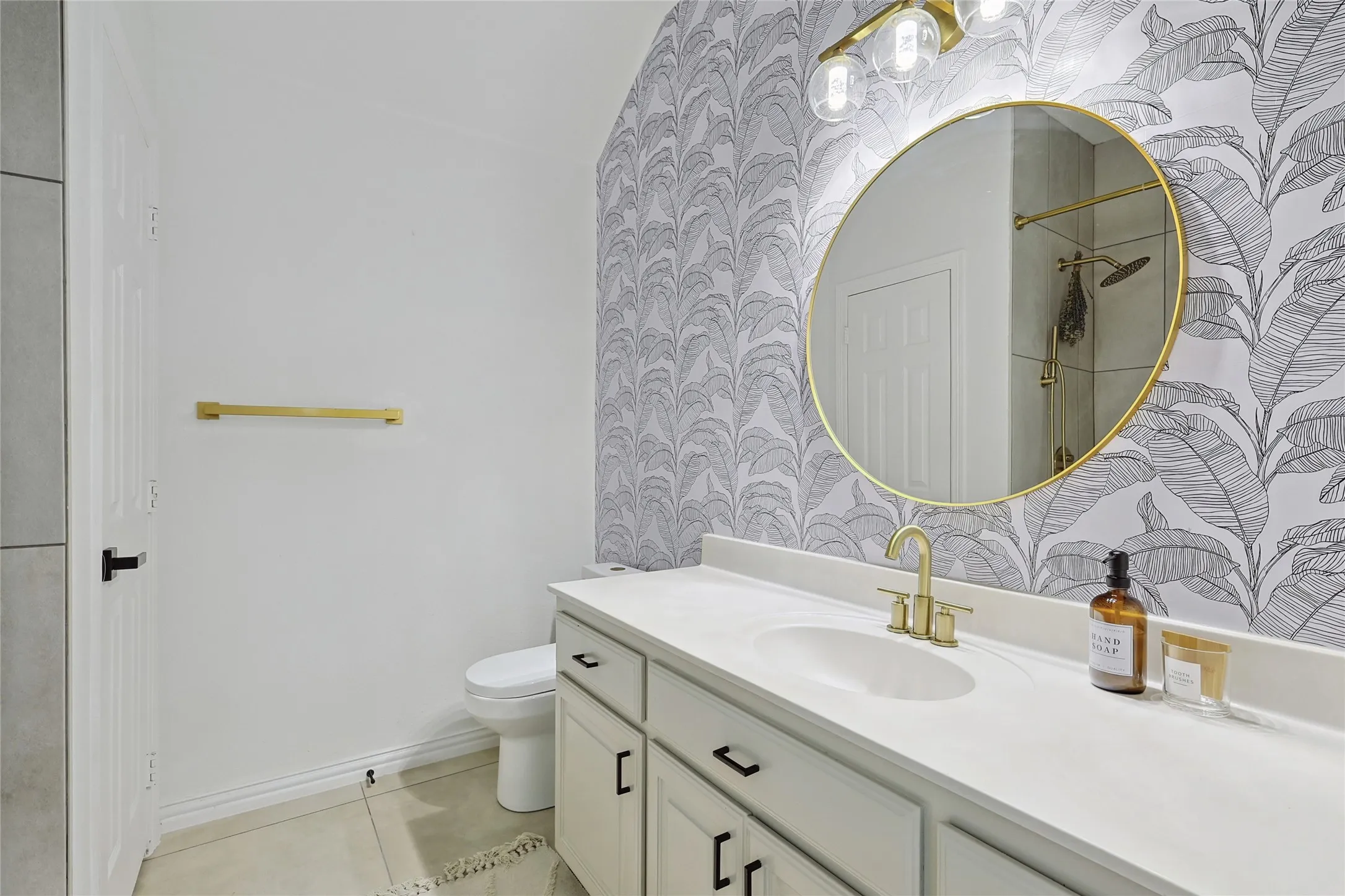 Bathroom featuring tile flooring, vanity, and toilet