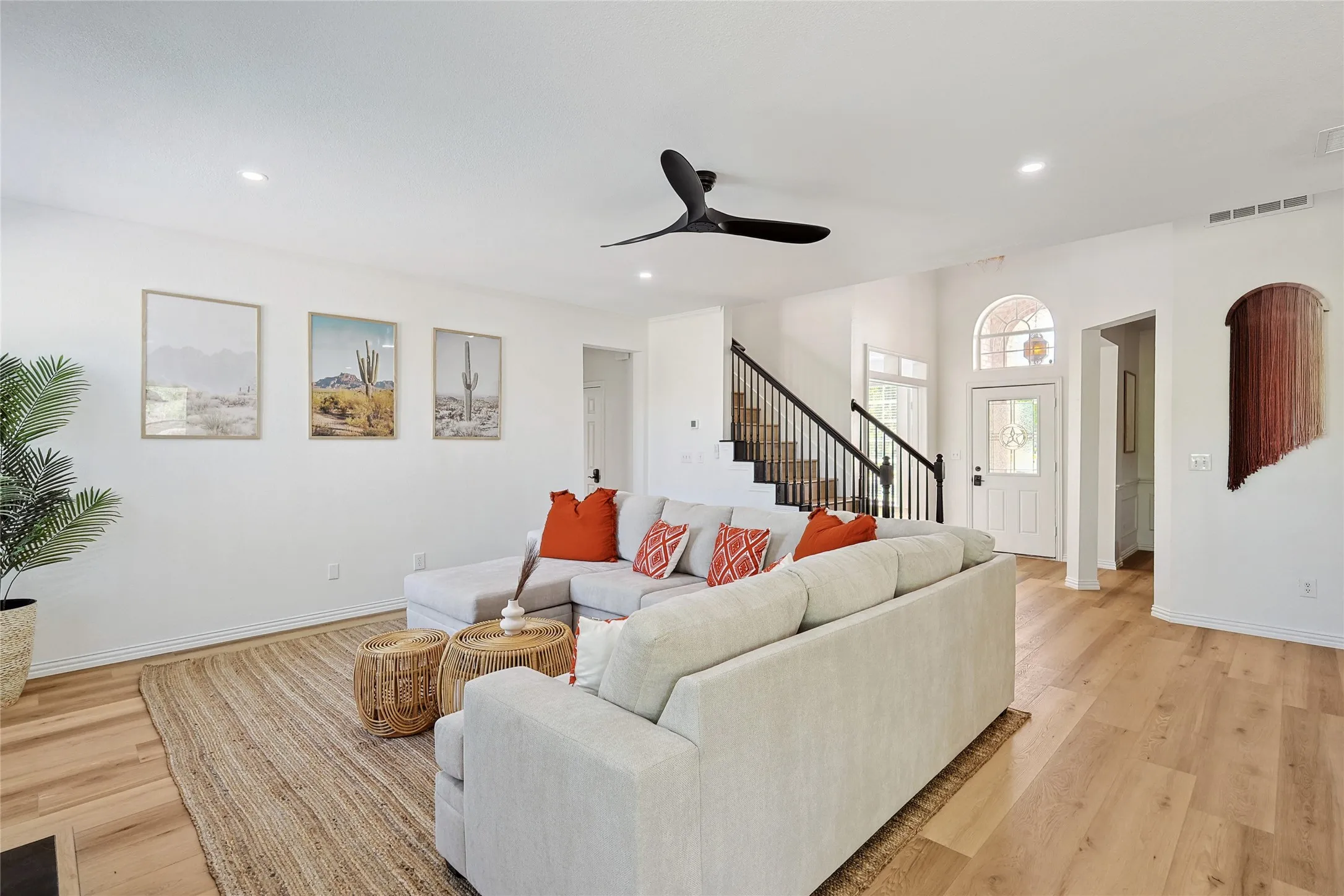Living room with ceiling fan and light hardwood / wood-style flooring