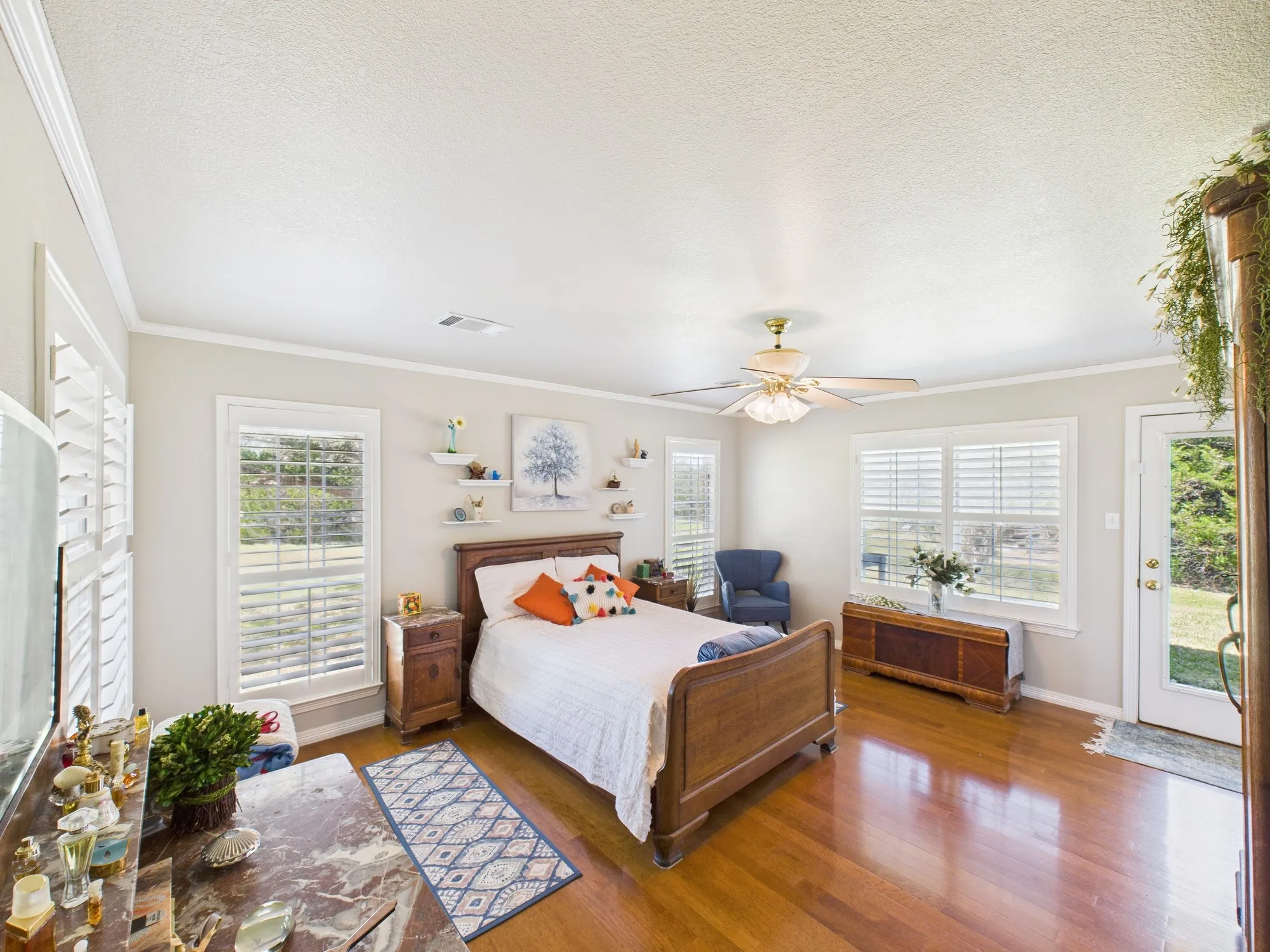 Lovely master bedroom with natural light or close the shutters for a dark room, door to backyard