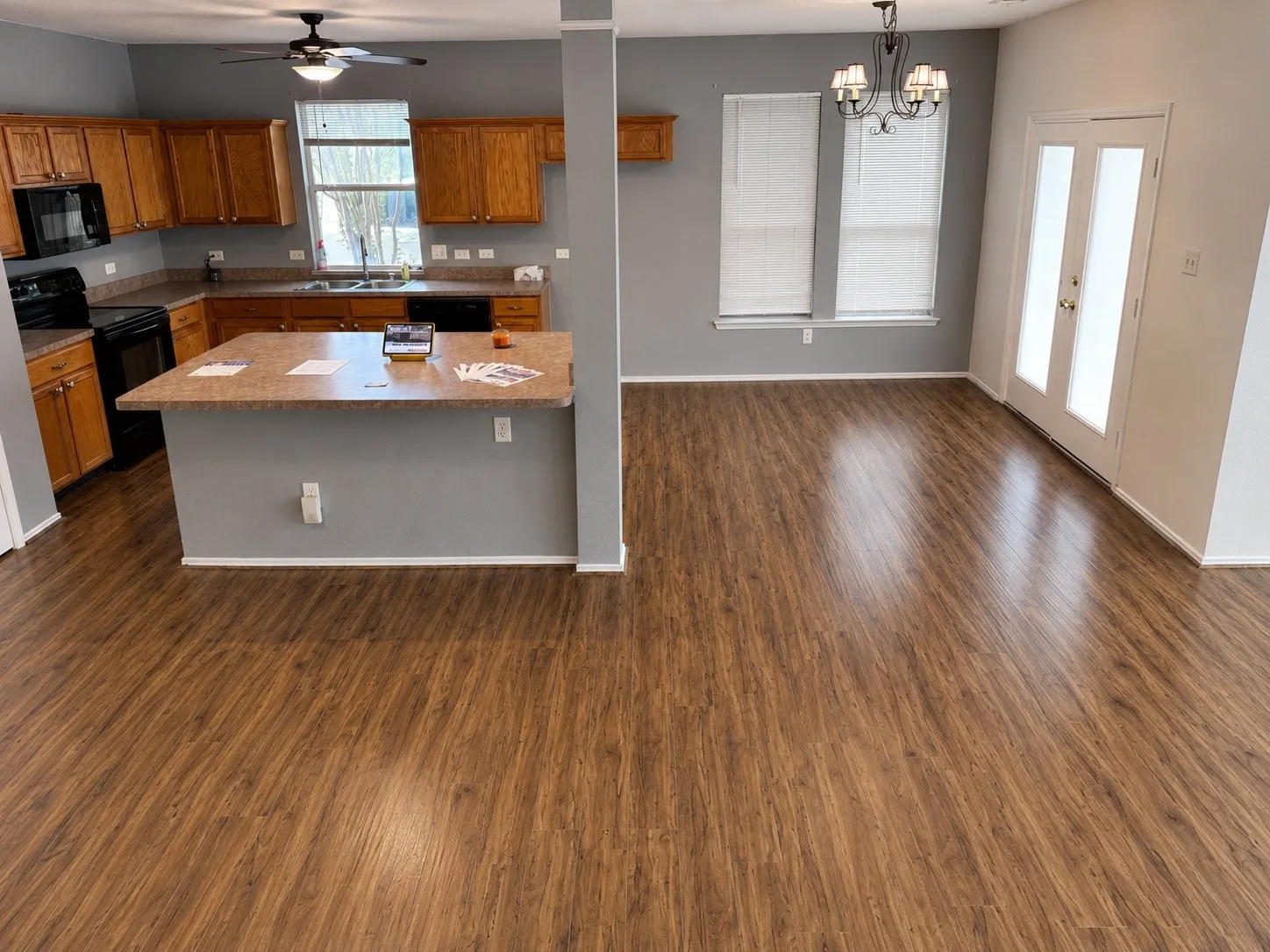 Open-concept living space featuring wood-finish flooring throughout